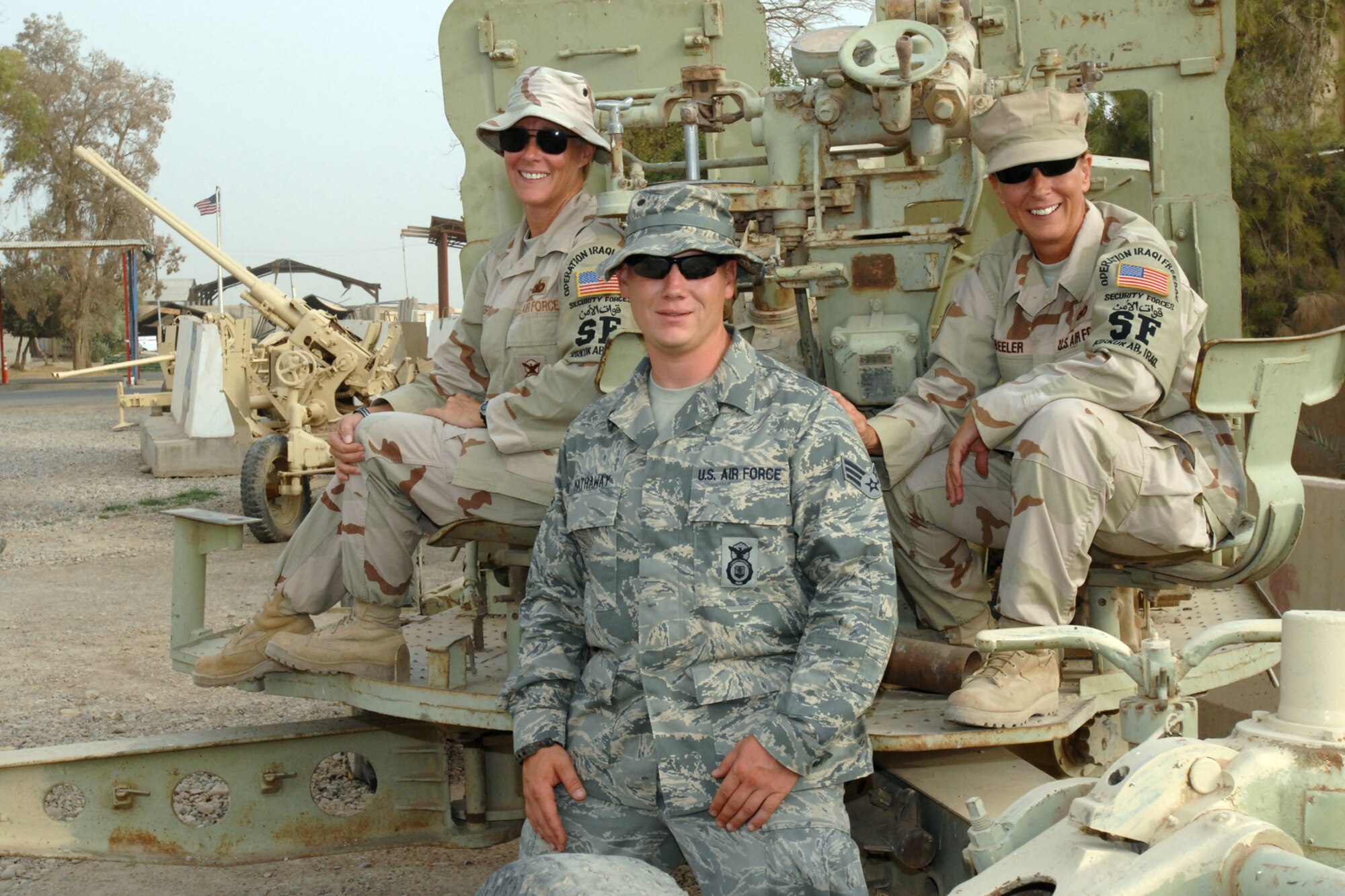 KIRKUK REGIONAL AIR BASE, Iraq -- SrA Benjamin Hathaway poses with his mother Tech. Sgt Kelly Beeler and his aunt Tech. Sgt. Kimberly McBride here August 7. They are all members of the 506th Expeditionary Security Forces Squadron. The three are reservists deployed here together from Maxwell Air Force Base, Ala., and Schriever AFB, Colo. (U.S. Air Force photo/Tech. Sgt. Jeff Walston)