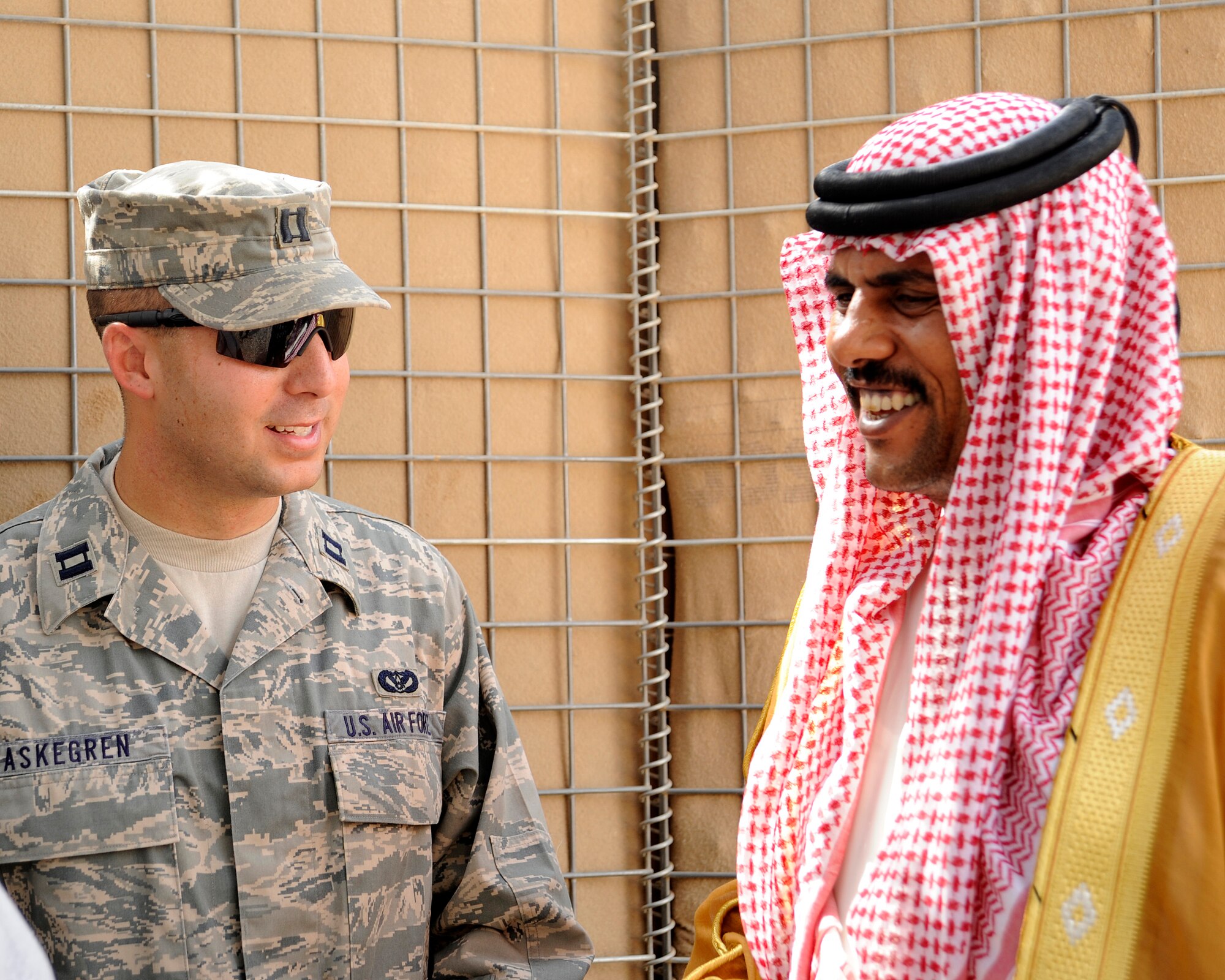 HAWR RAJAB, IRAQ -- U.S. Air Force Capt. Michael Askegren, Patrol Base Stone site officer in charge, left, talks with Sheik Mahier al-Mu'ini before the Village of Hope graduation ceremony in the city of Hawr Rajab, Iraq on Aug. 28. Askegren, a Mandeville, La. native, is deployed from the 823rd RED HORSE squadron, Hurlburt Field, Fla. where he is a project engineer. (U.S. Air Force photo/Staff Sgt. Paul Villanueva II)