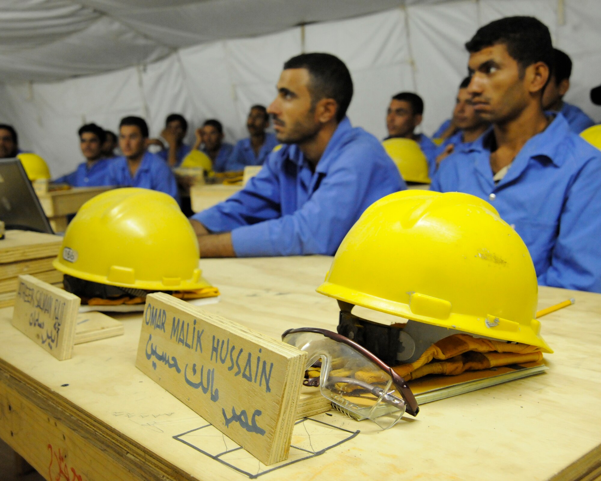 HAWR RAJAB, IRAQ -- Iraqi student workers listen to a lecture during the builders course of the Village of Hope program at Hawr Rajab, Iraq on Aug. 26. At the start of the course all students receive steel-toe boots, work gloves, coveralls, eye protection and a hard hat. (U.S. Air Force photo/Staff Sgt. Paul Villanueva II)