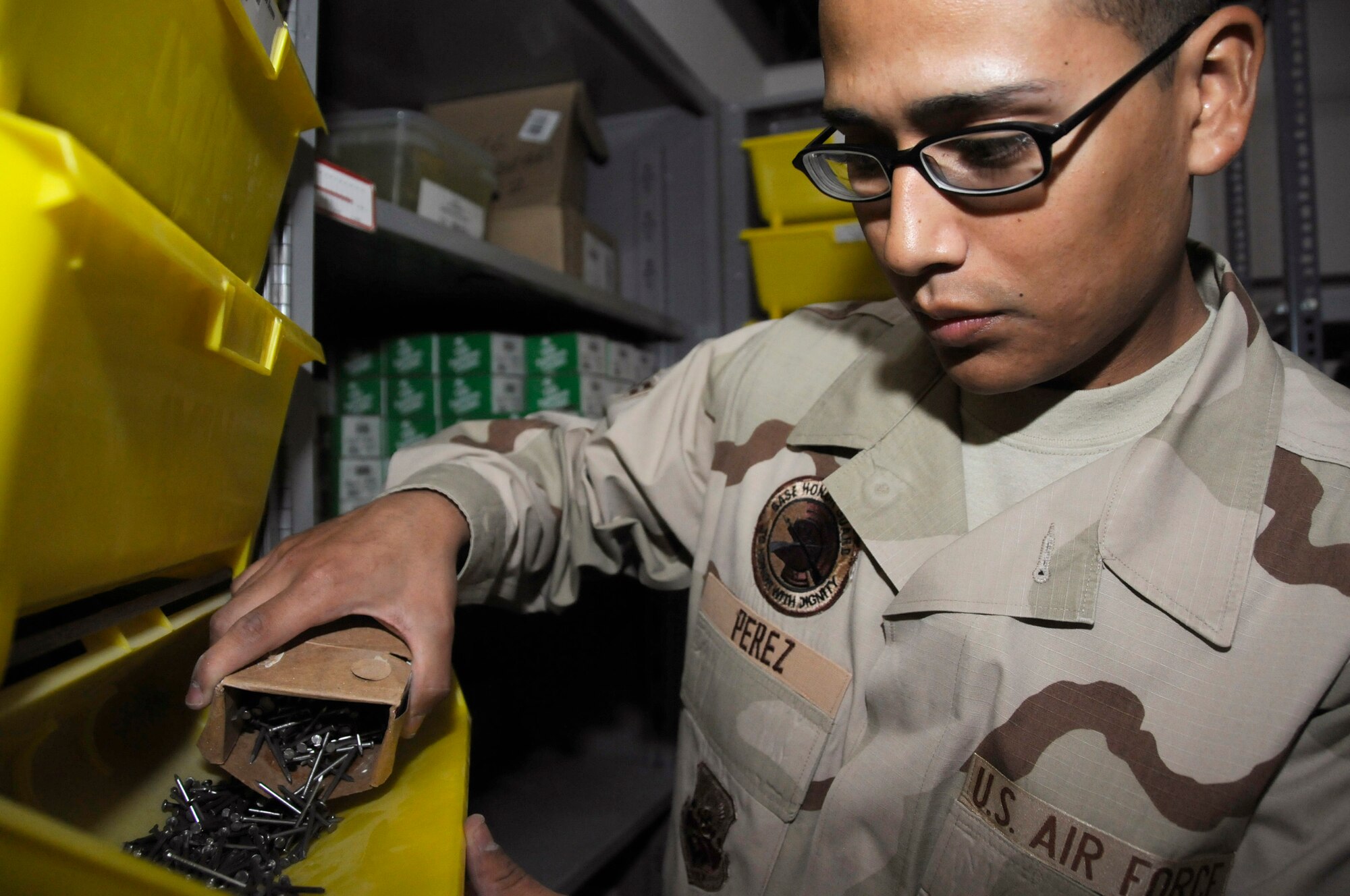 Airman 1st Class Eric Perez, assigned to the 379th Expeditionary Civil Engineer Squadron, restocks finishing nails in the screw and nail area of the base self help store Sept. 4, 2008. Airman Perez and others assigned to the 379th ECES are responsible for providing over 75,000 different building materials and supplies for facility maintenance projects at this undisclosed air base in Southwest Asia. They assist over 1,000 customers per month in support of Operations Iraqi Freedom, Enduring Freedom and Joint Task Force-Horn of Africa. Airman Perez, a native of Houston, Texas, is deployed from Eielson Air Force Base, Alaska. (U.S. Air Force photo by Staff Sgt. Darnell T. Cannady)
