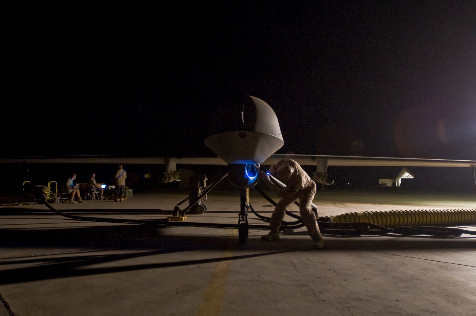 ALI BASE, Iraq -- Lt. Col. Geoffrey Barnes, Detachment 1 46th Expeditionary Reconnaissance Attack Squadron commander, performs a pre-flight inspection of an MQ-1B Predator unmanned aerial system Sept. 3, 2008. The Predator is a medium-altitude, long-endurance, remotely piloted aircraft. Its mission here is to interdict and conduct armed reconnaissance against critical and perishable targets in support of the Global War on Terrorism. Barnes is deployed from Creech Air Force Base, Nev. (U.S. Air Force photo/Airman 1st Class Christopher Griffin)