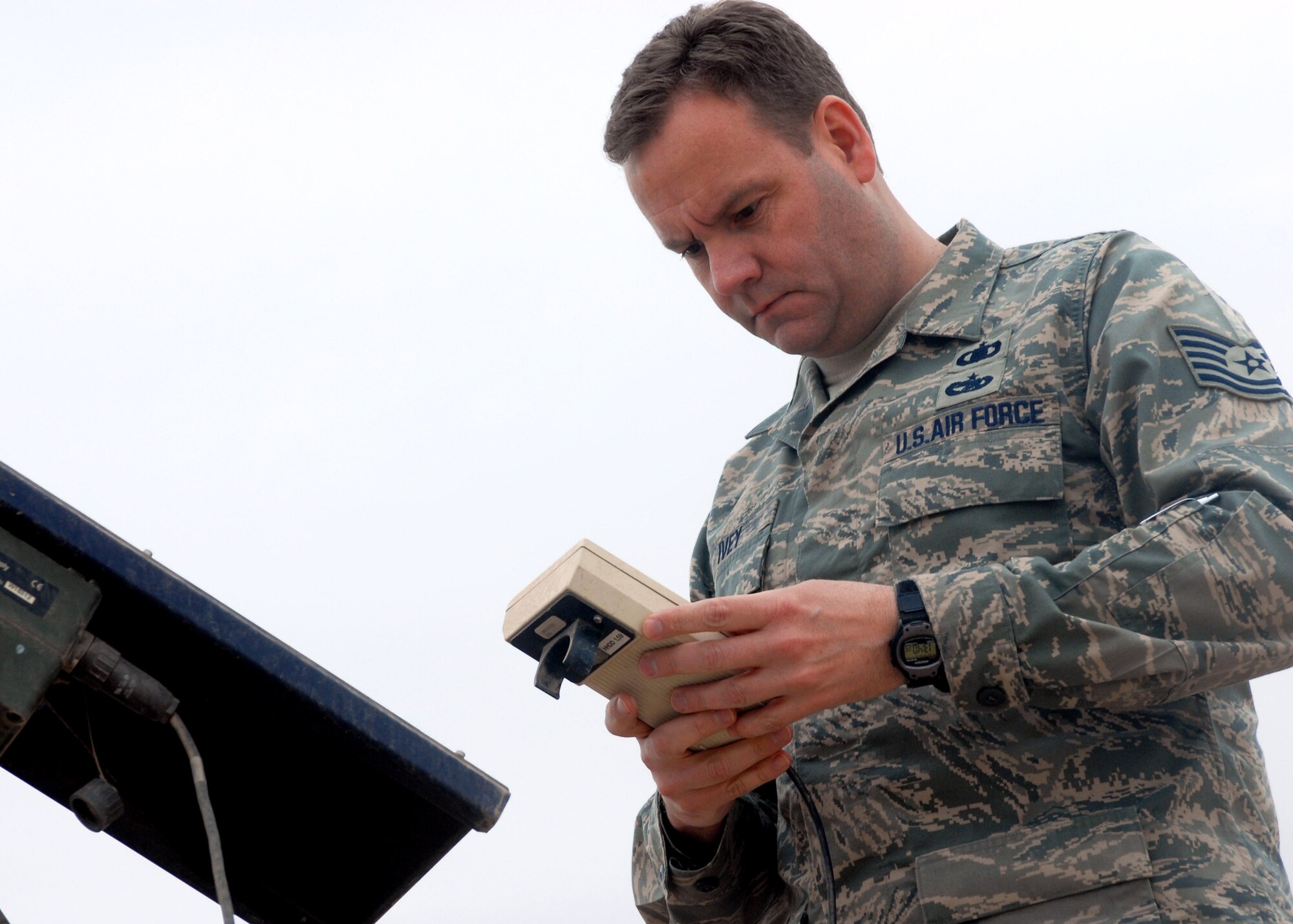 Tech. Sgt. David Ivey records weather data from the roof of the Task Force XII tactical operations center at Camp Taji, Iraq. Sergeant Ivey is one of a team of eight U.S. Air Force weather experts that support the aviation task force led by U.S. Army Europe's 12th Combat Aviation Brigade. (U.S. Army photo by Sgt. 1st Class Christopher Seaton)