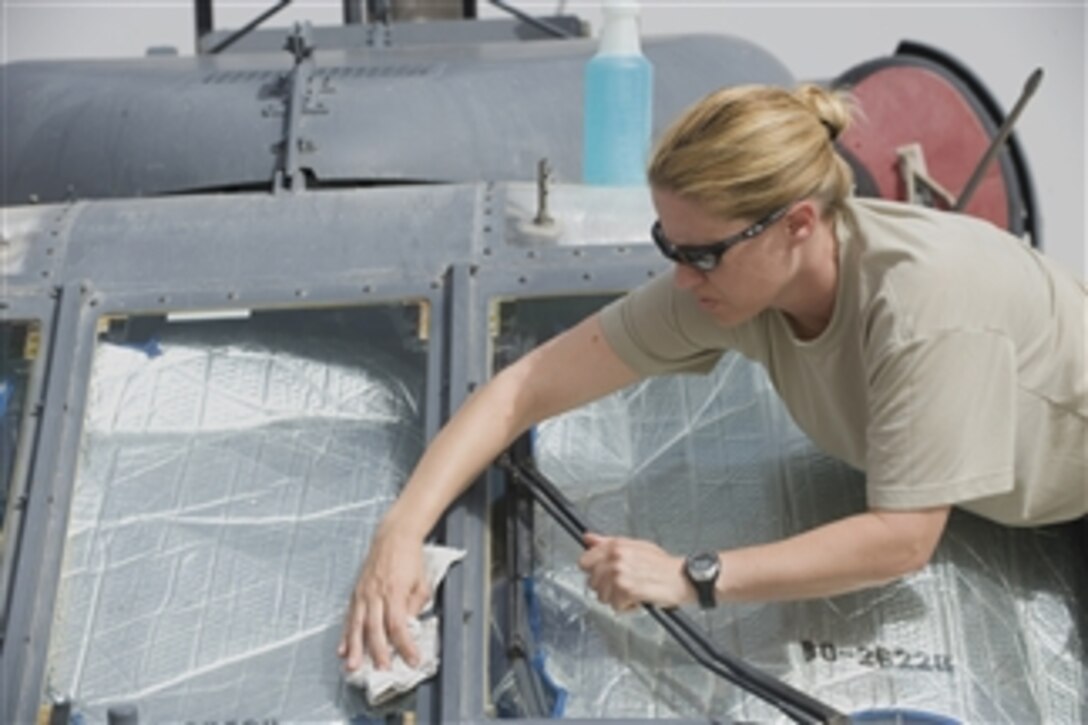 U.S. Air Force Tech. Sgt. Tricia Broenneka cleans windows on a HH-60 Pave Hawk helicopter before a flight at Kandahar Air Field, Afghanistan, on Aug. 15, 2008.  Broenneka is assigned to the 305th Expeditionary Rescue Squadron from Davis-Monthan Air Force Base, Ariz.  