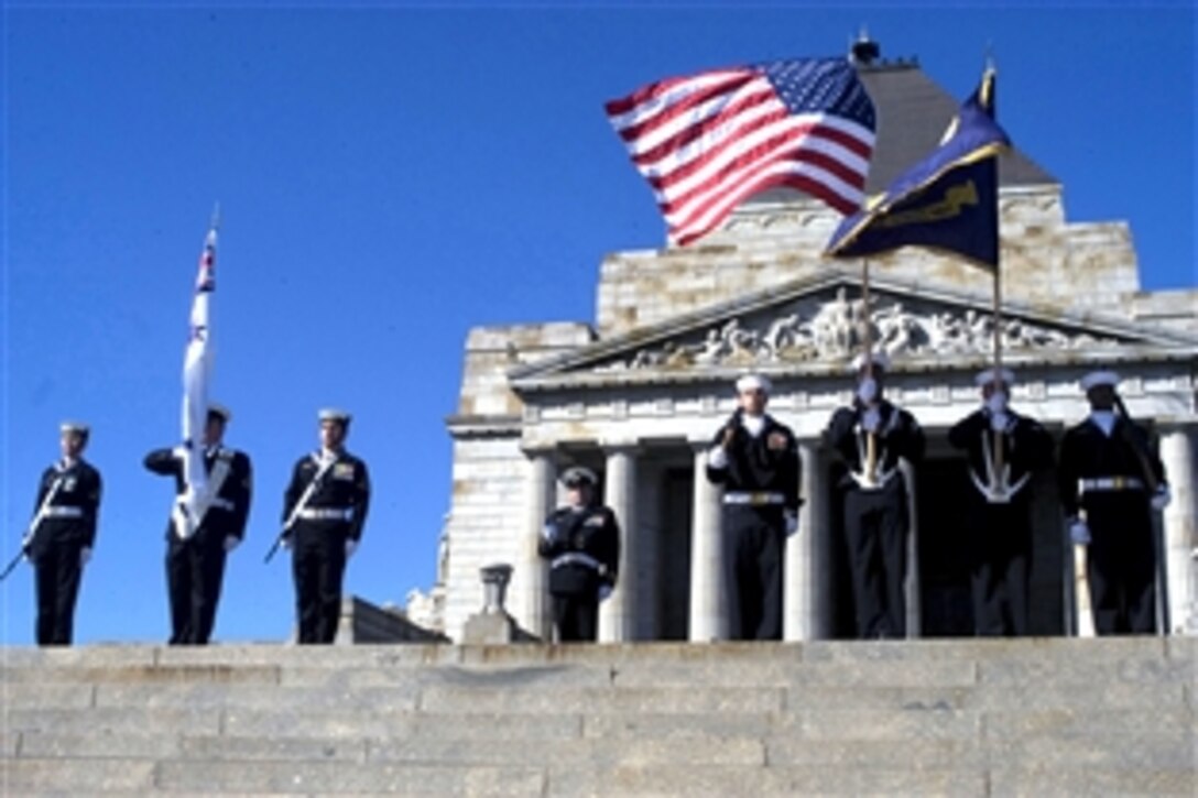 U.S. Navy sailors assigned to the color guard aboard the guided missile destroyer USS John S. McCain parade the colors during the Battle for Australia commemoration ceremony at the Shrine of Remembrance in Melbourne, Australia, Sept. 3, 2008. The USS McCain is visiting Melbourne to celebrate the centennial anniversary of the Great White Fleet.