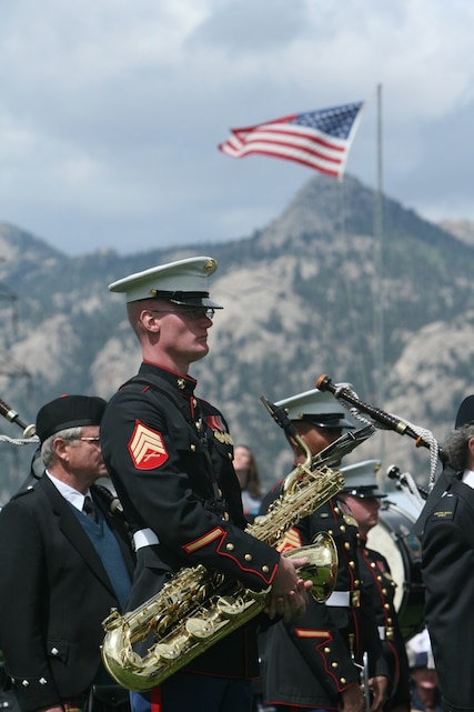 Sgt. Kyle Williams, baritone saxophone player for the Combat Center Band, stands in formation while waiting to perform for fans Sept. 6 at the Stanley Park Fairgrounds in Estes Park, Colo., during the town’s annual Long’s Peak Scottish-Irish Highland Festival.  Fans braved chilly nights, with the help of hot chocolate and hot dogs, to see the bands’ quick and crisp marches and hear their defined sound, which makes them a fan favorite where-ever they go.  While some may think the band is merely an act for the ears and eyes, fans in attendance admitted the band also served as a unique means of boosting their morale and patriotism.  The festival, which celebrates Celtic traditions, featured Celtic music concerts, jousting competitions, Scottish athletic events, dancing competitions, vendors, and a dog exhibition competition, among other things.
