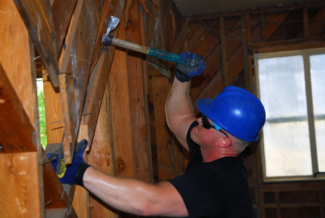 A member of the 149th Fighter Wing Civil Engineer Squadron, Lackland Air Force Base, San Antonio, Texas, helps with the internal demolition of a building on Camp Morena, California. The unit worked on real-world engineering projects for the U.S. Navy and the Southwest Border Mission while simultaneously completing two weeks of training.