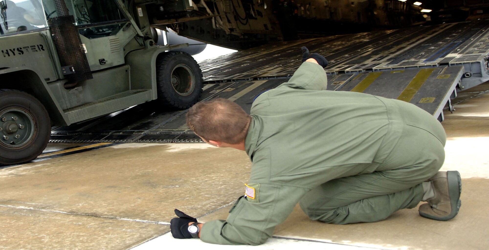 Staff Sgt. Dustin Canterbury, C-17 loadmaster from Altus Air Force Base, Okla. checks the clearance of a 10K forklift being loaded onto the plane. Medical supplies and vehicles were loaded up at MacDill AFB, Fla. before heading to Beaumont, Texas to prepare for Hurricane Gustav evacuation efforts. (U.S. Air Force photo/Staff Sgt. Joseph Swafford Jr.)