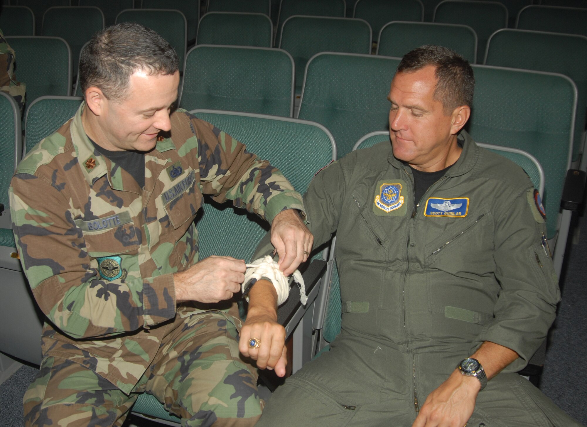 Maj. Armand Bolotte and Lt. Col. Scott Quinlan of 123rd Airlift Wing Headquarters, practice self-aid and buddy care skills. (Photo by Capt. John Stamm/KyANG)
