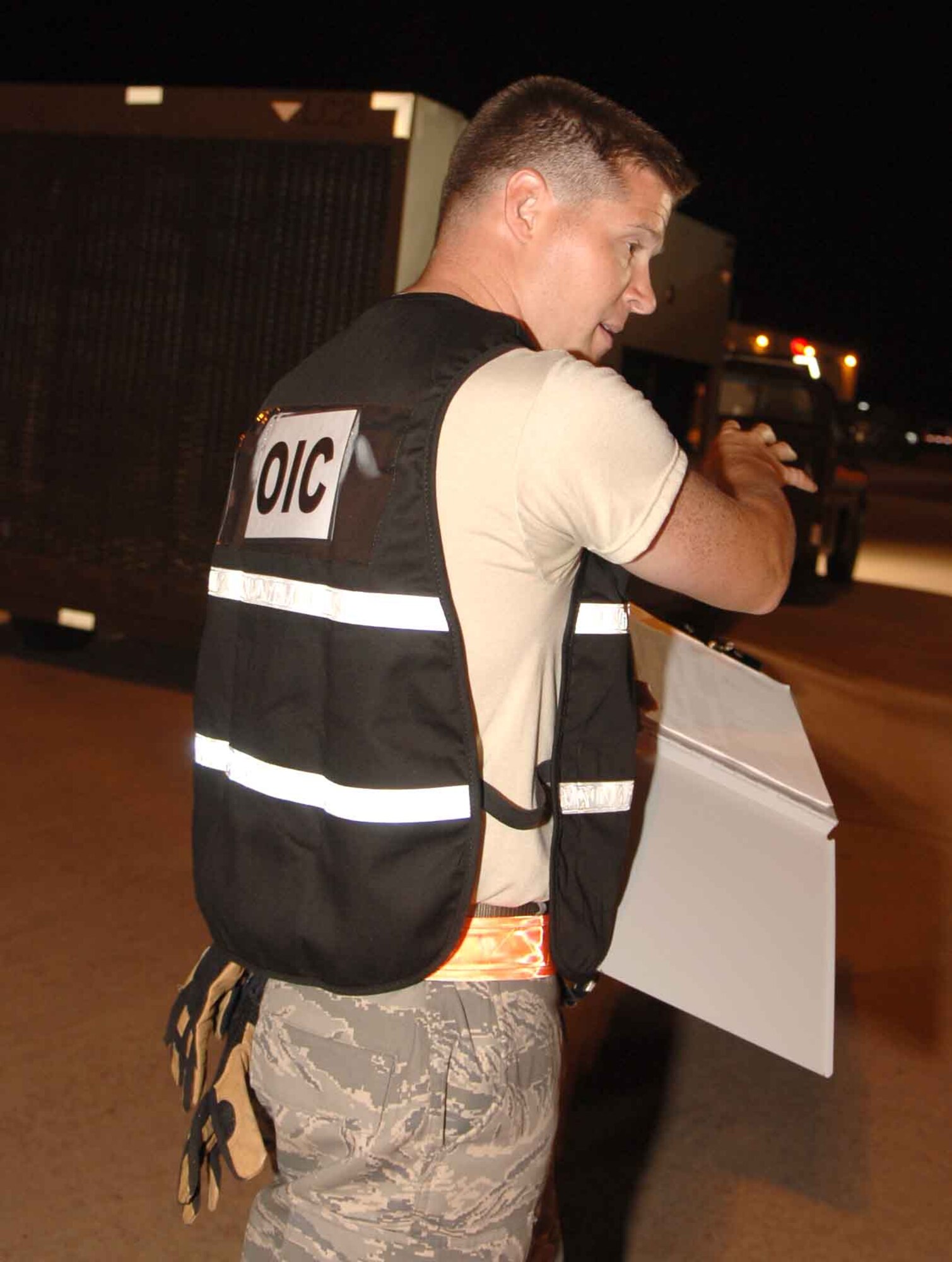 DYESS AIR FORCE BASE, Texas – 2nd Lt. Justin Coffey, 7th Logistics Readiness Squadron Air Terminal Operations officer-in-charge, carries personal protective equipment and wears reflective gear in the cargo yard here Sept. 6. Any time Airmen are near loud or heavy equipment, the wing safety office says they should use hearing protection, wear steel-toed boots, and carry gloves. Airmen are also required to wear reflective gear 30 minutes prior to sundown and 30 minutes after sunrise. (U.S. Air Force photo/Senior Airman Carolyn Viss)