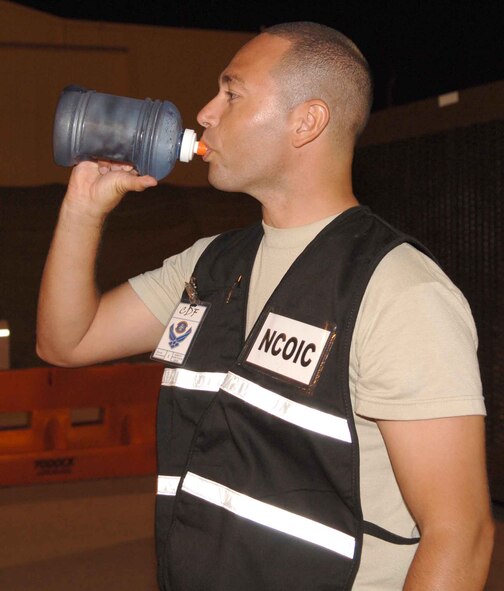 DYESS AIR FORCE BASE, Texas – Tech. Sgt. Juan Cruz, 7th Logistics Readiness Squadron, takes a break from his 12-hour night shift to hydrate during the 7th Bomb Wing Operational Readiness Exercise here Sept. 6.  The wing safety office recommends Airmen drink at least 10 to 12 eight-oz. glasses of water during any shift in order to avoid heat stress. Airmen who work longer-than-average shifts or who have larger body mass should drink even more. (U.S. Air Force photo/Senior Airman Carolyn Viss)
