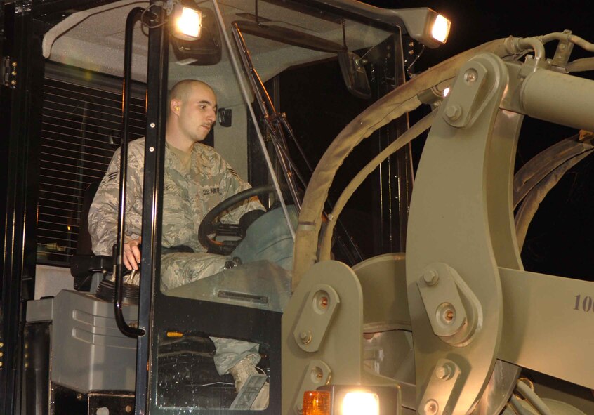 DYESS AIR FORCE BASE, Texas – Senior Airman Ken Coy, 7th Logistics Readiness Squadron, moves cargo into place in the yard near the flightline here during the 7th Bomb Wing Operational Readiness Exercise Sept. 6. (U.S. Air Force photo/Senior Airman Carolyn Viss)