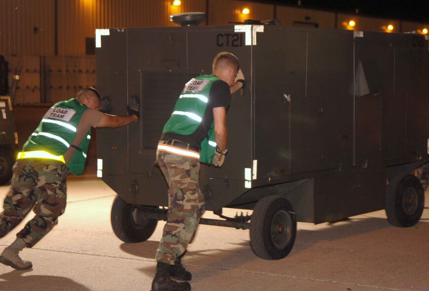 DYESS AIR FORCE BASE, Texas – Members of the 7th Logistics Readiness Squadron Air Terminal Operations move cargo in the yard near the flightline here during the 7th Bomb Wing Operational Readiness Exercise Sept. 6. Members of Air Terminal Ops work 24/7 to ensure cargo is air worthy before it leaves the base. (U.S. Air Force photo/Senior Airman Carolyn Viss)