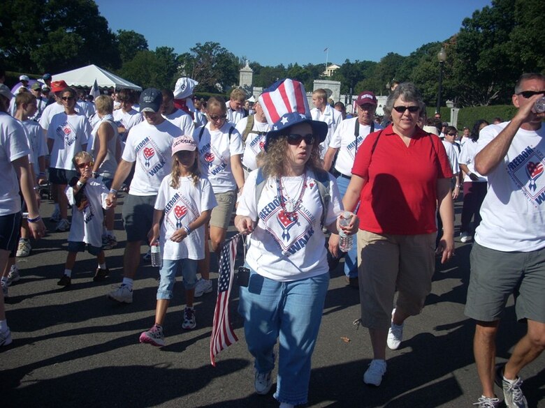 Wearing an oversized red, white and blue hat, Sarah Bauman of Alexandria, Va., departs from the starting point of the Fourth Annual America Supports You Freedom Walk Sept. 7, in Washington, D.C. The Freedom Walk is one of 330 such events designed to remember the Sept. 11, 2001, terrorist attacks on the United States. 
 (U.S. Air Force photo/Senior Master Sgt. Matt Proietti)