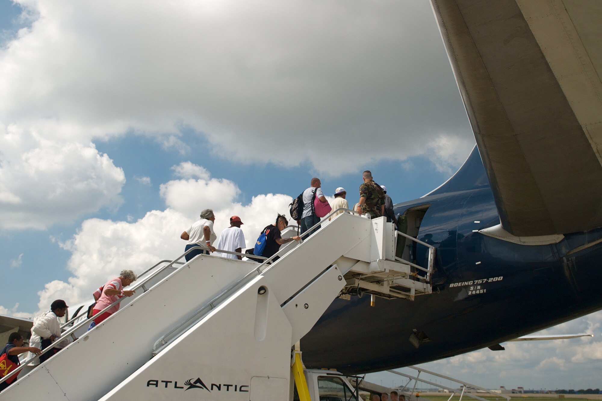 Hurricane Gustav evacuees board a commercial airliner at the Kentucky Air Guard Base for a flight home Sept. 6. Nearly 1,500 Gulf Coast evacuees spent about a week at a Red Cross Shelter at the Kentucky Exposition Center in Louisville. (Photo by Capt. Dale Greer, Kentucky Air National Guard.)