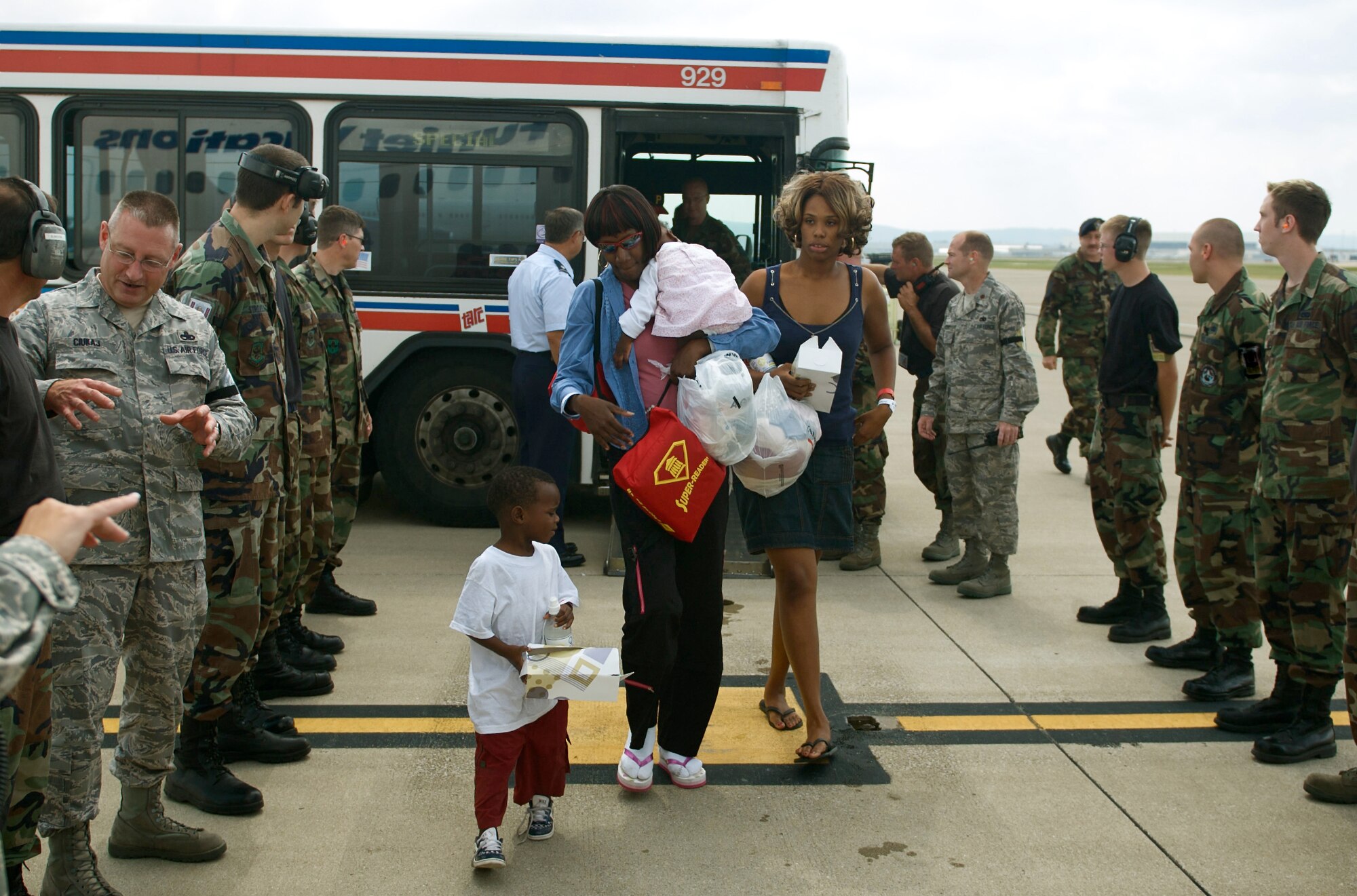 Hurrican Gustav evacuees step off a Transit Authority of River City bus before boarding a flight back to New Orleans on Sept. 6 as members of the Kentucky Air National Guard bid them farewell on the base flightline. The New Orleans-area residents spent about a week in a Red Cross Shelter at the Kentucky Exposition Center in Louisville. (Photo by Capt Dale Greer, Kentucky Air National Guard.)