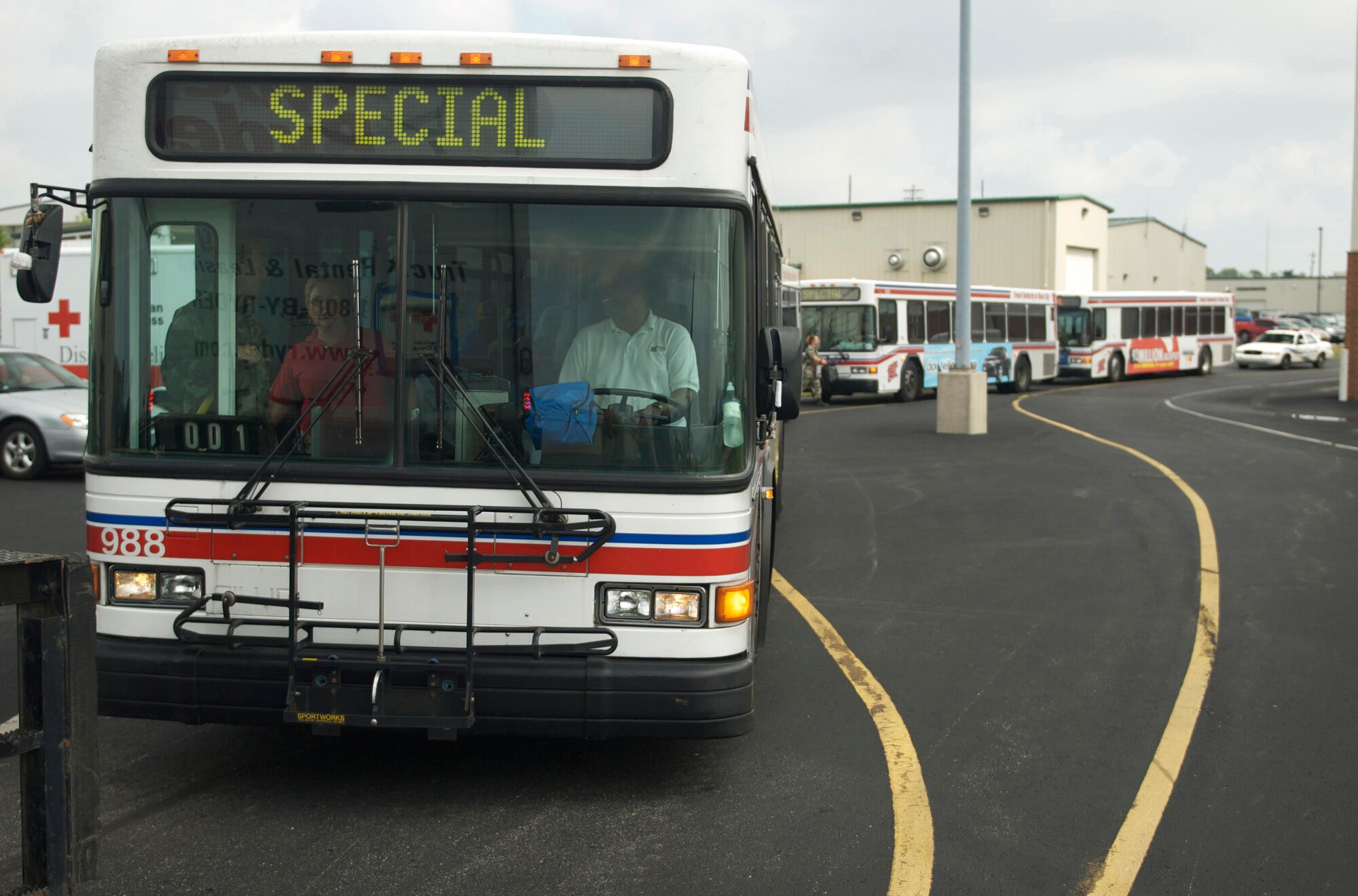 Transit Authority of River City buses carrying Hurricane Gustav evacuees wait to enter the flightline at the Kentucky Air National Guard Base on Sept. 6. The New Orleans-area residents began returning home after spending abut a week in a Red Cross Shelter at the Kentucky Exposition Center in Louisville. (Photo by Capt Dale Greer, Kentucky Air National Guard.)