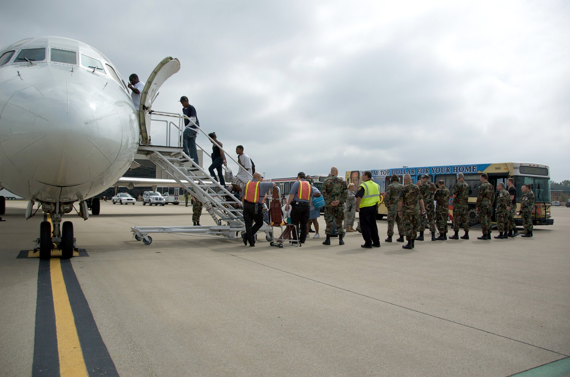 Hurricane Gustav evacuees board a commercial airliner at the Kentucky Air Guard Base for a flight home Sept. 6. Nearly 1,500 Gulf Coast evacuees spent about a week at a Red Cross Shelter at the Kentucky Exposition Center in Louisville. (Photo by Capt. Dale Greer, Kentucky Air National Guard.)