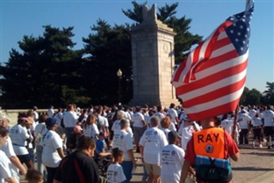 A participant in the 4th annual America Supports You Freedom Walk in Washington D.C., carries an American flag as the walkers head for the Pentagon, Sept. 7, 2008. The walk is a national tradition that calls on people to reflect on the lives lost on Sept. 11, 2001, remember those who responded, honor our veterans past and present and renew our commitment to freedom and the values of our country. 