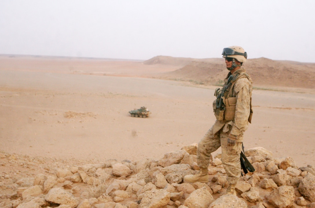 Cpl. Brandon J. Frazer searches in the province's west for traces of insurgent activity during an area sweep Sept. 7 by 2nd Light Armored Reconnaissance Battalion, Regimental Combat Team 5. Frazer, 21, is a scout team leader from Kissimmee, Fla., serving with Alpha Company, 2nd LAR Bn.