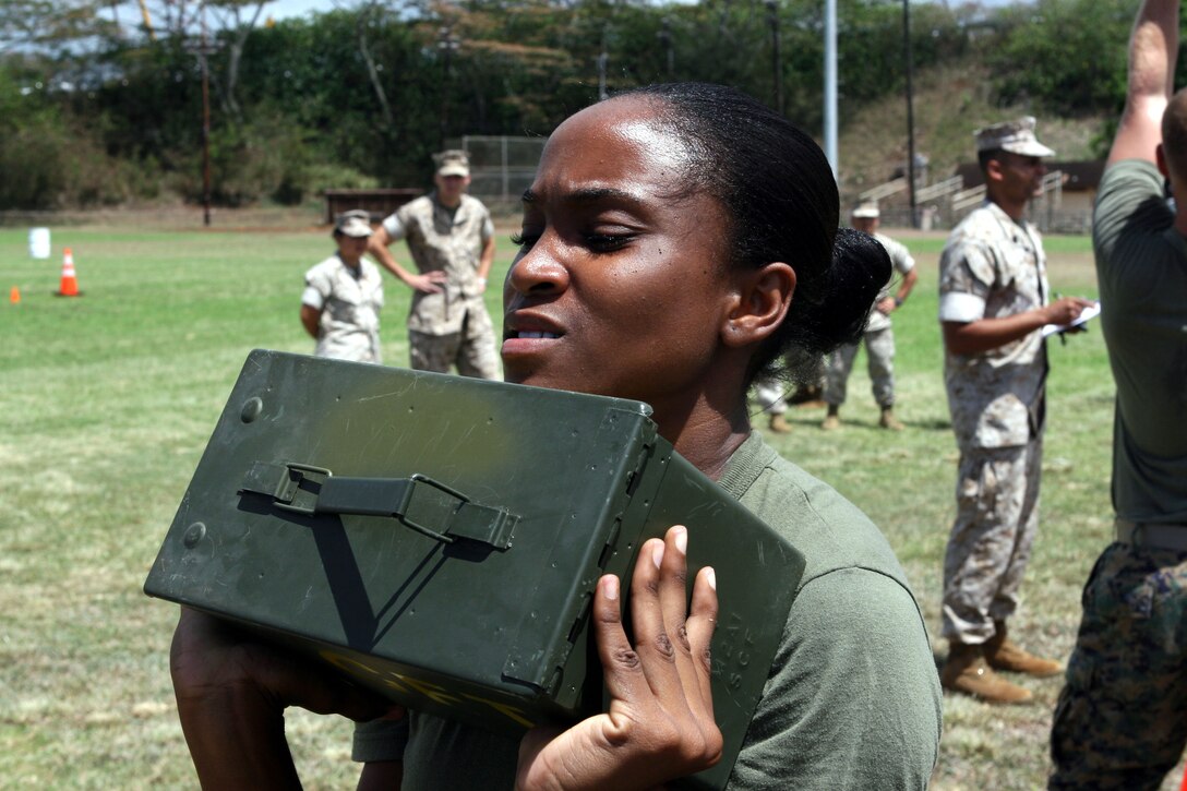 Lance Cpl. Aphila Robinson, administration clerk with Headquarters and Service Battalion, U.S. Marine Corps Forces, Pacific, takes a quick breather during the two minute ammo-can lift as part of the Training and Education Command combat fitness test road show demonstration held at Bordelon Field Sept. 8.