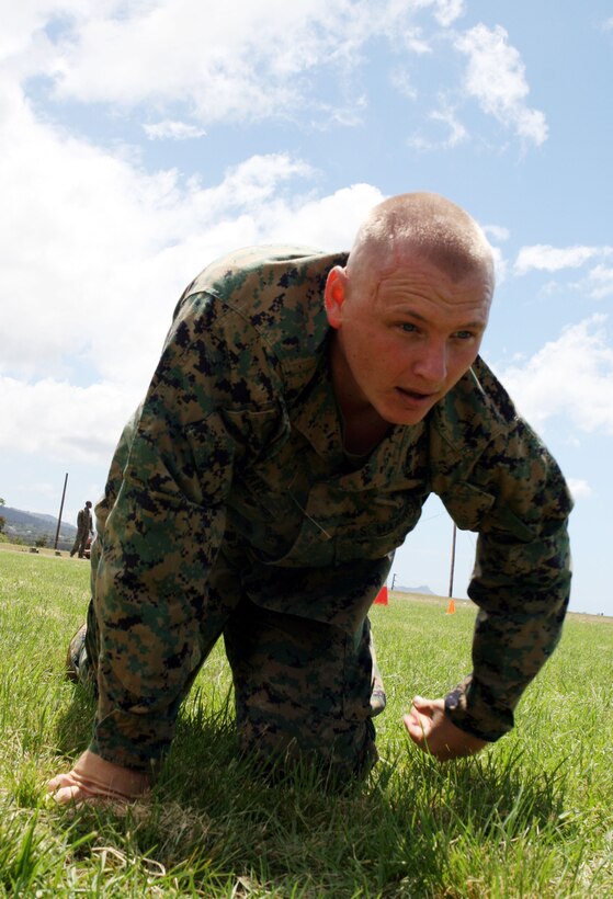 Gunnery Sgt. Mark O’Hare, company gunnery sergeant for Headquarters and Service Battalion, U.S. Marine Corps Forces, Pacific, performs the modified high crawl during the Training and Education Command combat fitness test road show demonstration held at Bordelon Field Sept. 8.::r::::n::TECOM is currently traveling to Marine Corps bases around the globe demonstrating the CFT. ::r::::n:: Visiting Camp Smith, MarForPac Marines gained the knowledge of what was to be expected from the CFT and the endurance it will take to complete the course. ::r::::n::“I thought it was good, but it was tough,” O’Hare said.::r::::n::O’Hare admitted the test became difficult in the final portion after the fireman carry and the ammo-can run, but attributed his drive to complete the course to intestinal fortitude.::r::::n::“You never can quit and you’re always pushing for something,” O’Hare said.::r::::n::