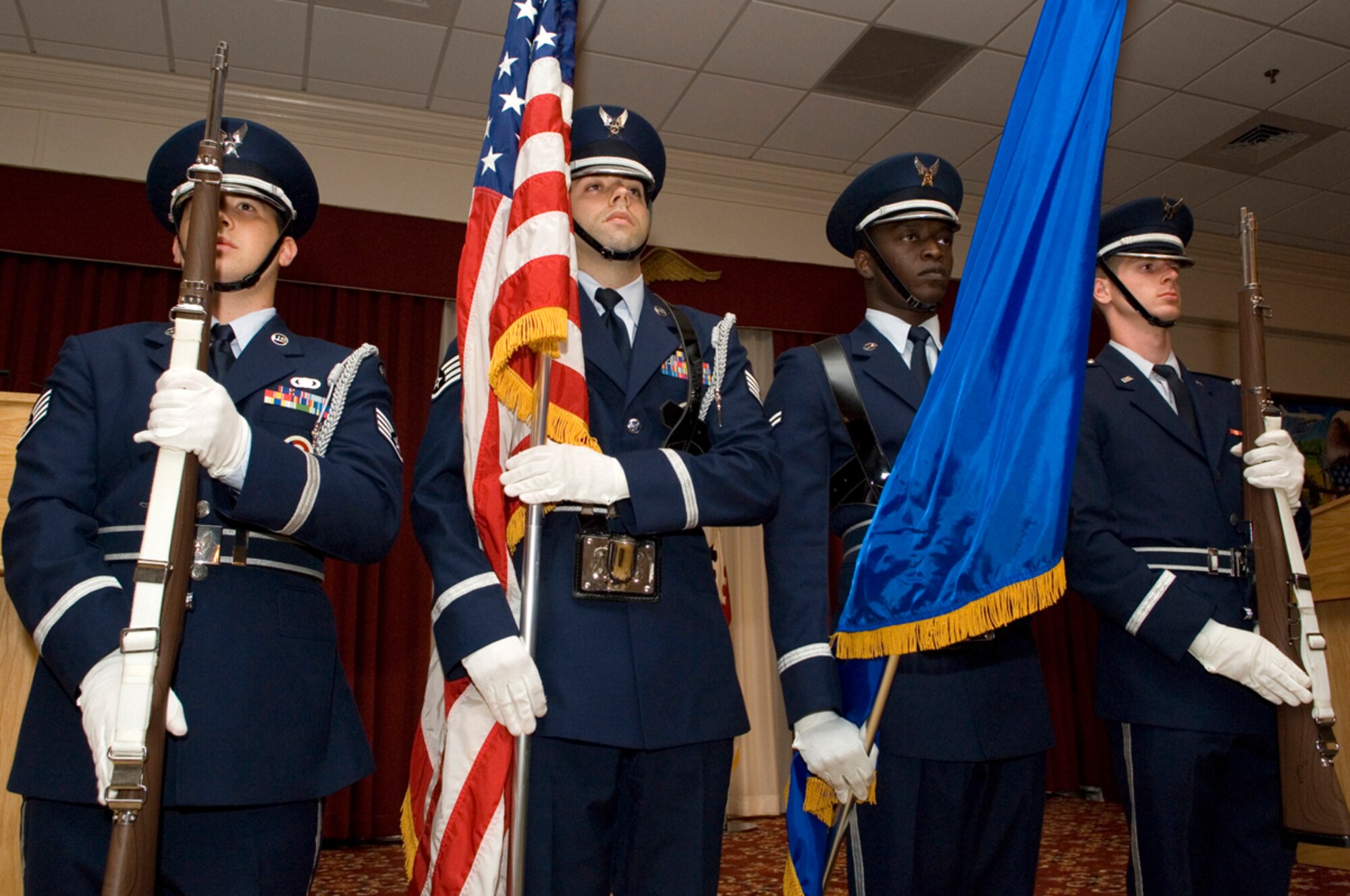 HANSCOM AFB, Mass. -- Hanscom Honor Guard members Staff Sgt. Jeremy Bridges, Staff Sgt. Philip Pelletier, Airman 1st Class Charles Lewis and 2nd Lt. Mike Verlinden, present the colors to open the Senior Noncommissioned Officer Induction ceremony here, Sept. 4. Nineteen Airmen were inducted into the SNCO corps during the ceremony. (U.S. Air Force photo by Mark Wyatt)