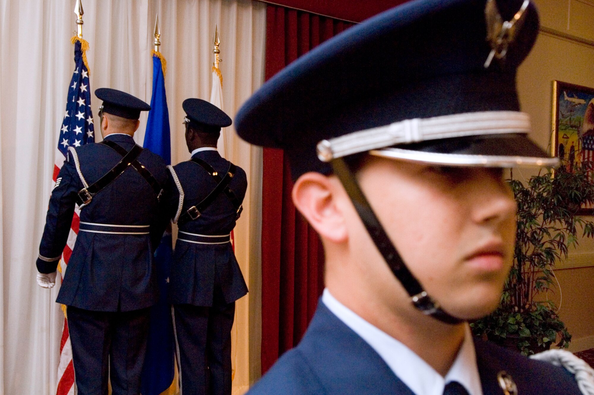 HANSCOM AFB, Mass. -- Staff Sgt. Philip Pelletier and Airman 1st Class Charles Lewis post the colors while Staff Sgt. Jeremy Bridges stands at attention during the opening of the Senior Noncommissioned Officer Induction ceremony here, Sept. 4. Sergeant Pelletier is assigned to the 66th Services Squadron Honor Guard, Sergeant Bridges is assigned to the 66th Comptroller Squadron, and Airman Lewis is assigned to the 66th Mission Support Squadron. Nineteen Airmen were inducted into the SNCO corps during the ceremony. (U.S. Air Force photo by Mark Wyatt)