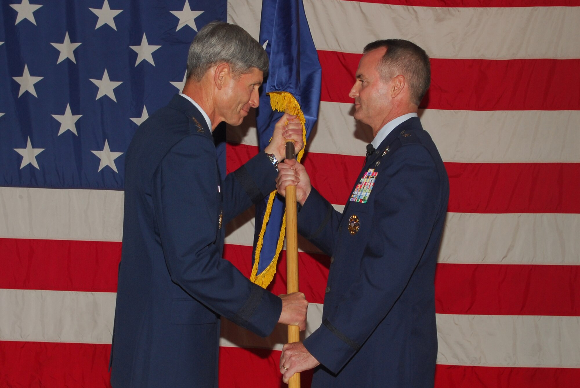 U.S. Air Force Chief of Staff Gen. Norton A. Schwartz presents 325th Fighter Wing commander and newly promoted general officer Brig. Gen. Darryl Roberson with his one-star flag.  (U.S. Air Force photo by Lisa Norman)
