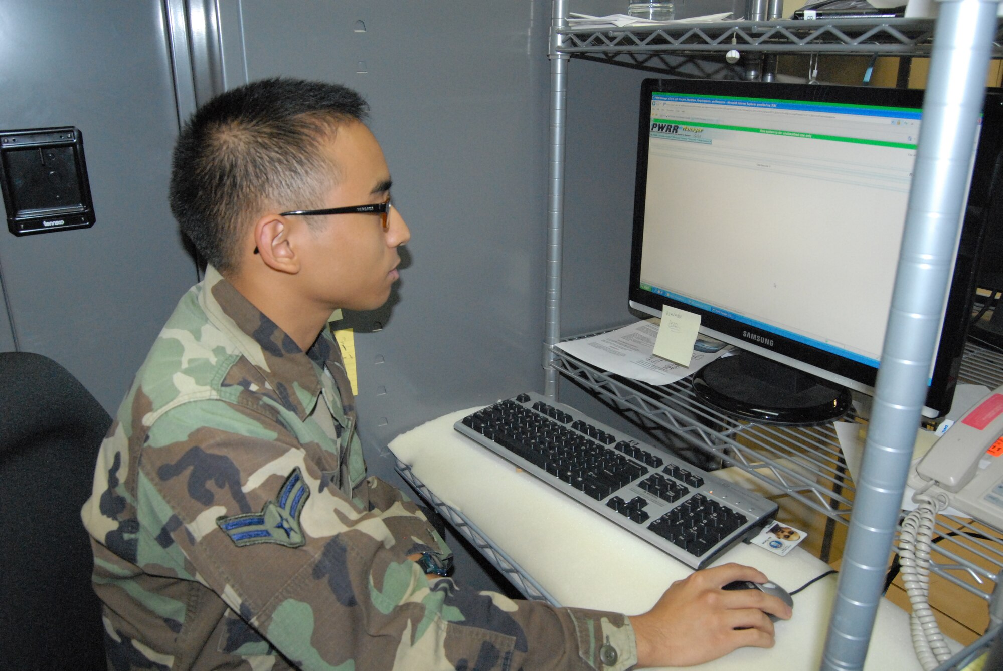 Airman 1st Class Anthony Cayetano, 43rd Communications Squadron, works to review work orders around base and then assigns the workers to solve those problems.  (U.S. Air Force Photo by Emily Smith)
