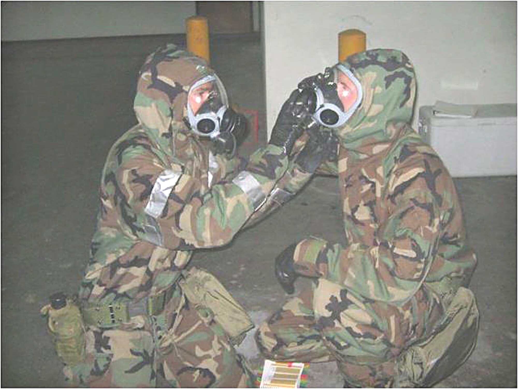 Two members of the 728th Air Mobility Squadron do gas mask buddy checks during the En Route Readiness Inspection Aug. 23-27. The 728 AMS underwent two simultaneous inspections, coming out on top with ratings of ‘Excellent’ for both.