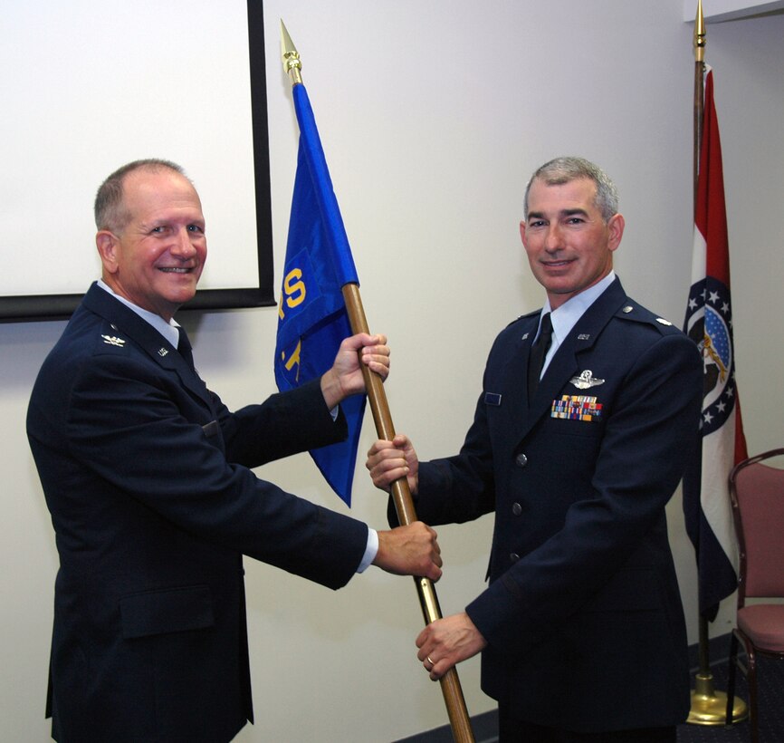 Col. Keith A. Smith presents incoming commander, Lt. Col. Michael Harrell the flag of the 131st Logistics Readiness Squadron (LRS). The Change of Command Ceremony was held on Sat. September 6th. (Photo by Tech. Sgt. Megan Hunter)