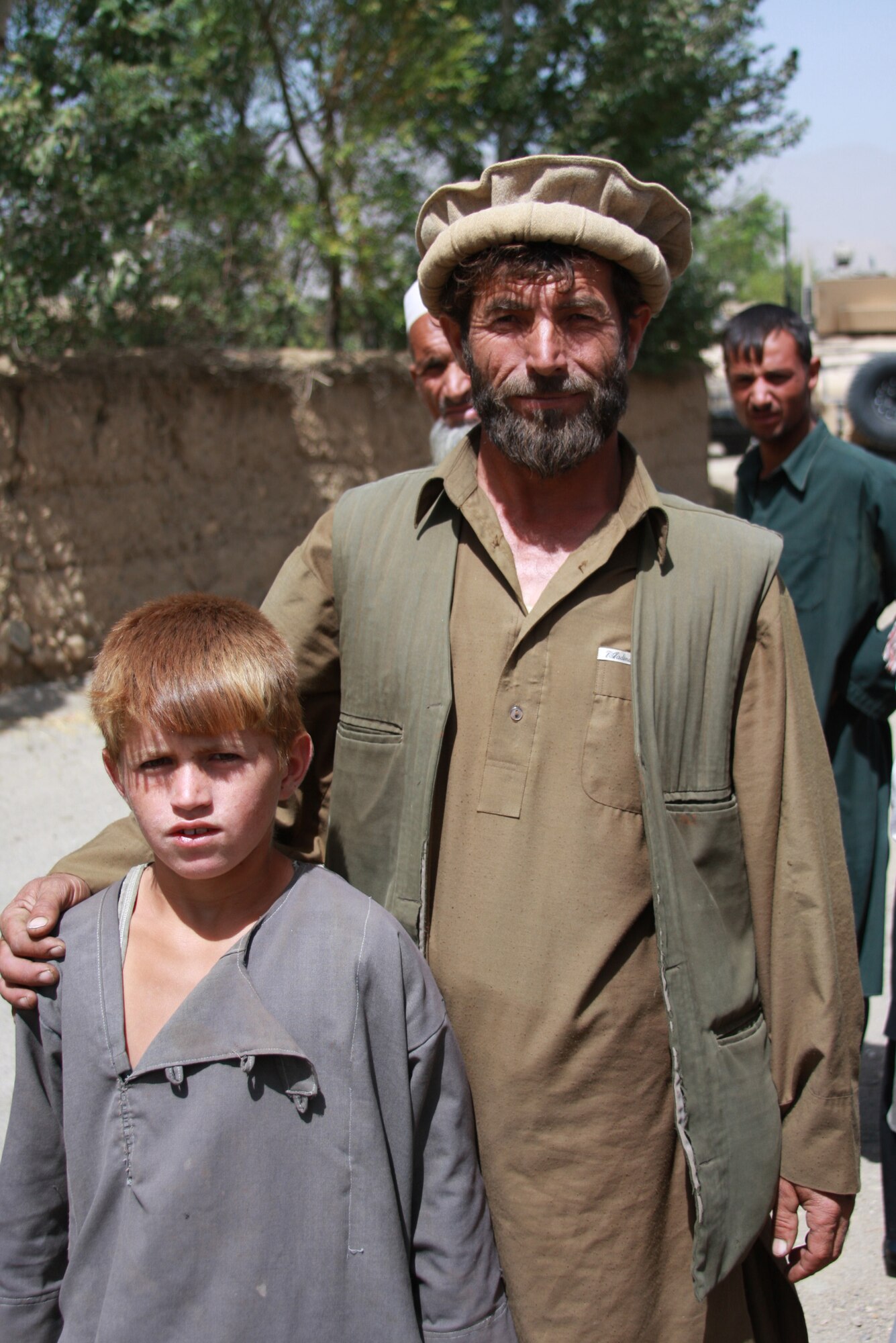 A local farmer pauses for a photo with his son during a ribbon cutting ceremony in Parwan Province, Afghanistan, September 6. The farmer donated land for the Chinaki Uyla Medical Clinic.
