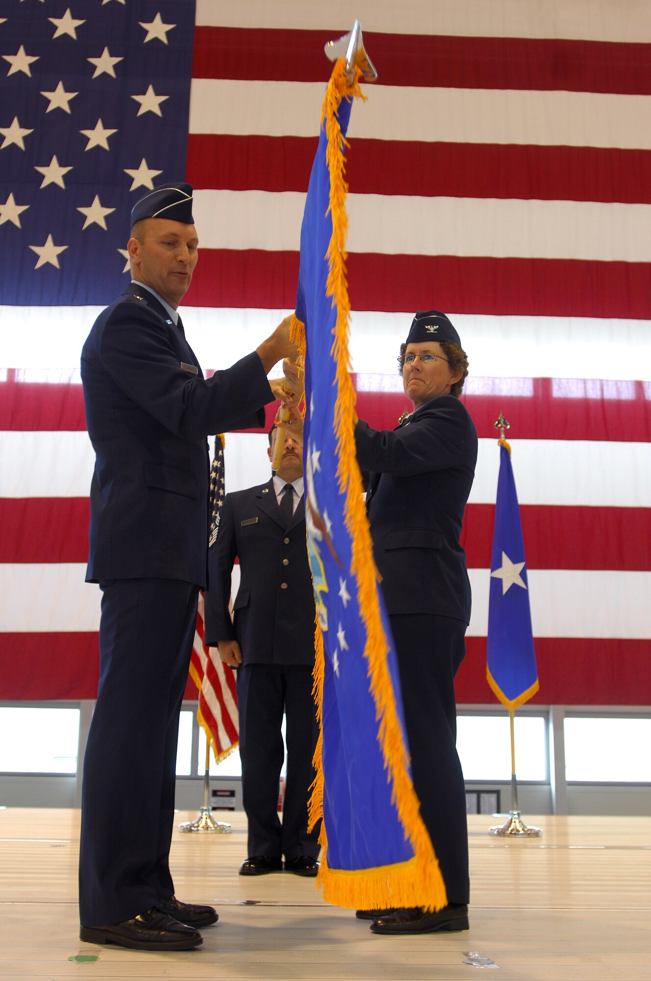 United States Air Force Brig. Gen. Timothy M. Zadalis (left), 21st Expeditionary Mobility Task Force commander, passes the guideon to Col. Kimberly J. Corcoran, new Commander of the 521st Air Mobility Operations Wing, during an activation of command ceremony, Ramstein Air Base, Germany, Sept. 4, 2008. (U.S. Air Force photo by Airman 1st Class Kenny Holston)(Released)