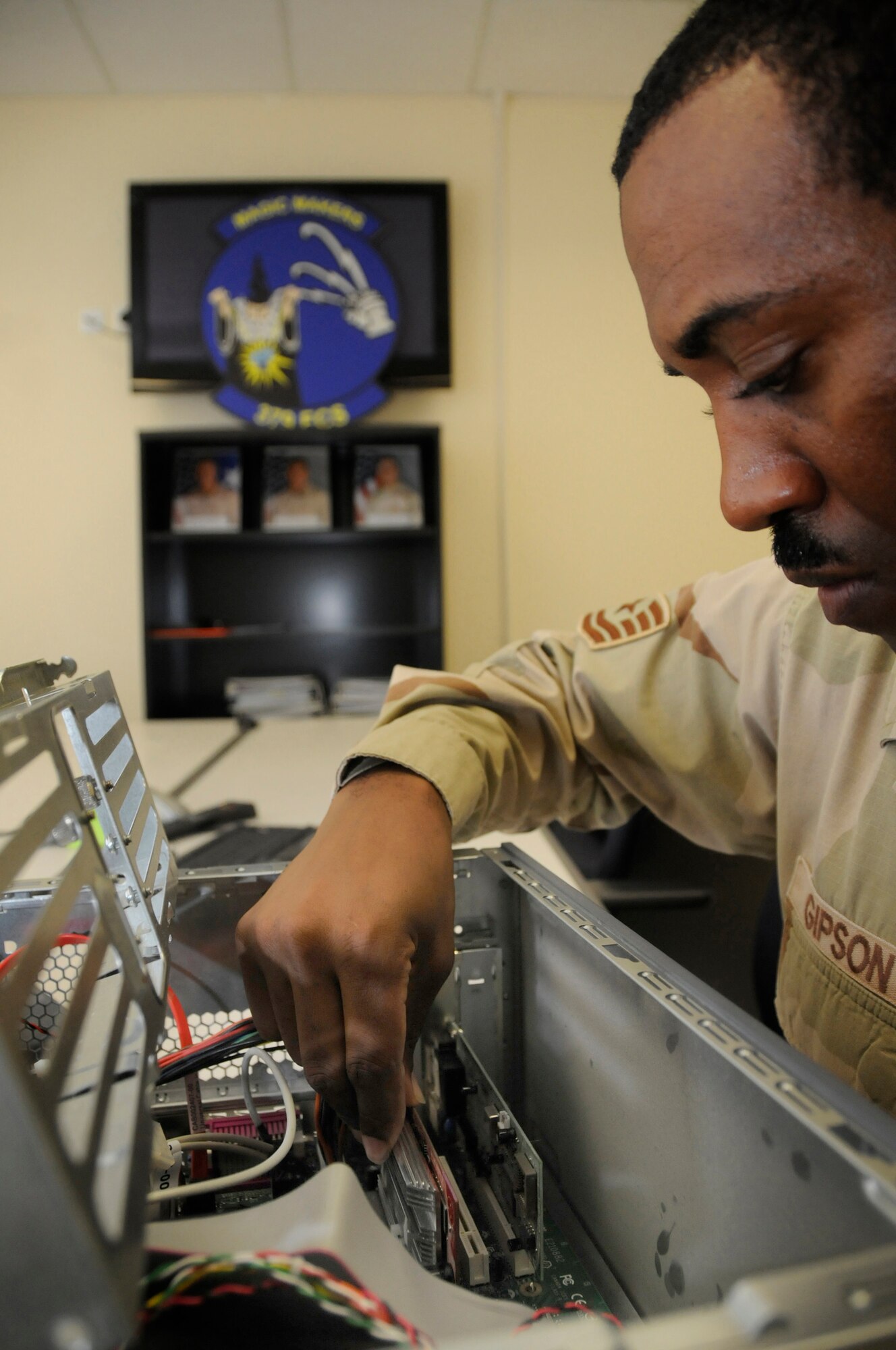 Tech. Sgt. Thomas Gipson, resource advisor for the 379th Expeditionary Communications Squadron, installs dual video cards in a personal computer Sept. 7, 2008, at an undisclosed location in Southwest Asia. Sergeant Gipson and other resource advisors here approve and purchase communications devices for use in support of Operations Iraqi and Enduring Freedom and Joint Task Force-Horn of Africa. Sergeant Gipson, a native of Waycross, Ga., is deployed from Scott Air Force Base, Ill. (U.S. Air Force photo by Staff Sgt. Darnell T. Cannady/Released)