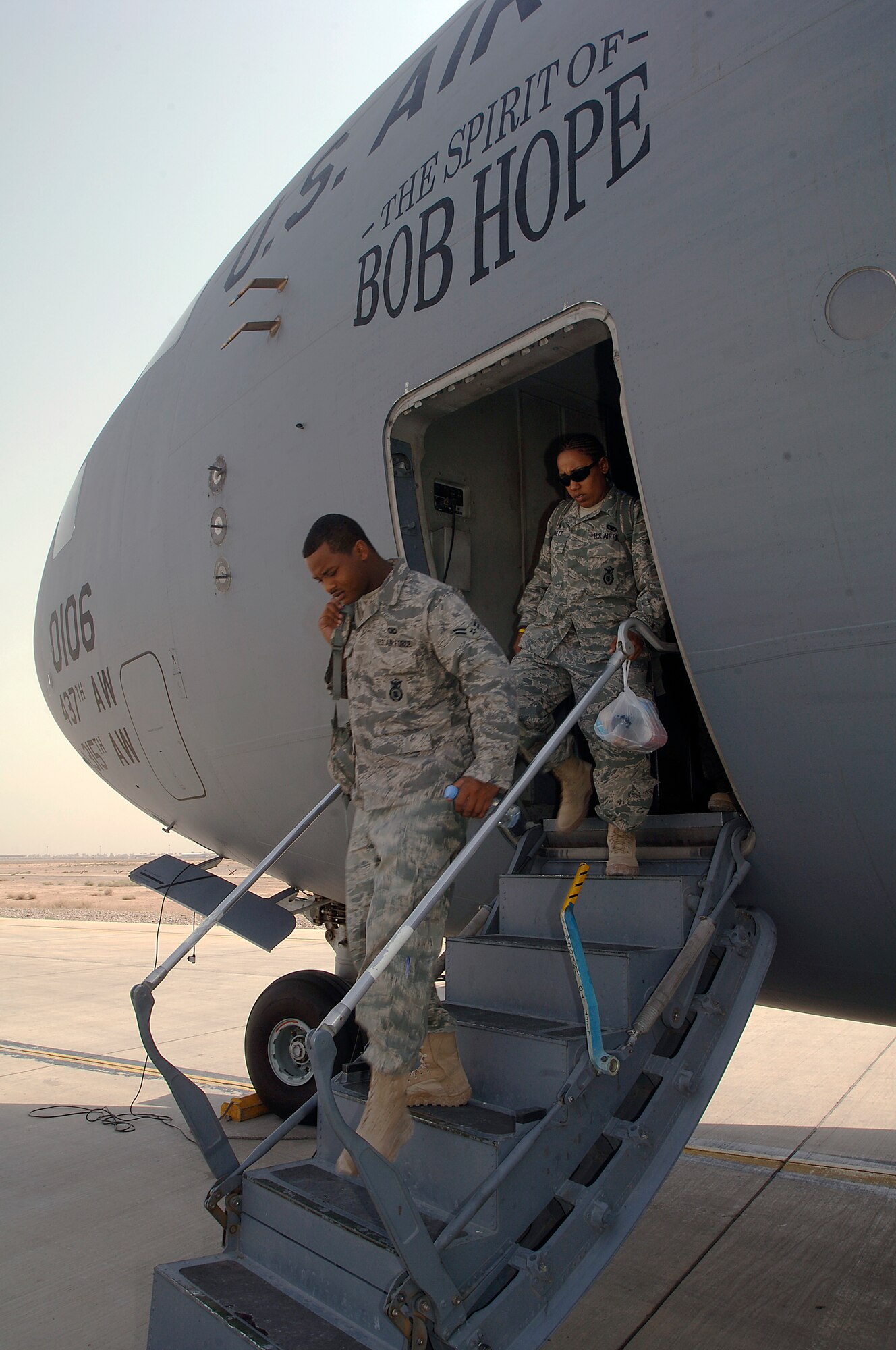 JOINT BASE BALAD, Iraq -- Security forces Airmen disembark a C-17  Globemaster III here Aug. 30 as part of a 332nd Expeditionary Security Forces Group buildup. Upon reaching full strength in September, the 332nd ESFG will assume responsibility for the Joint Defense Operations Center, law enforcement, flightline security, force protection escorts, base entry points, quick reaction forces, perimeter towers, base badging, housing area security and other missions. (U.S. Air Force photo/Tech Sgt. Erik Gudmundson)