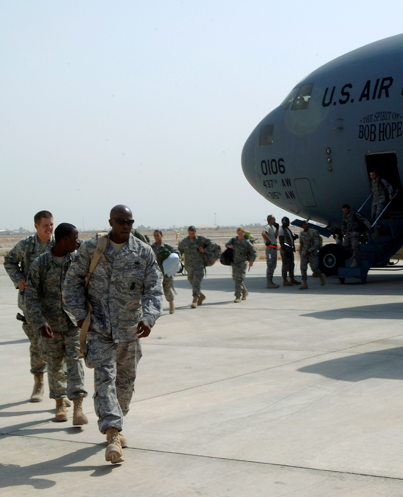 JOINT BASE BALAD, Iraq -- Security forces Airmen disembark a C-17  Globemaster III here Aug. 30 as part of a 332nd Expeditionary Security Forces Group buildup. Upon reaching full strength in September, the 332nd ESFG will assume responsibility for the Joint Defense Operations Center, law enforcement, flightline security, force protection escorts, base entry points, quick reaction forces, perimeter towers, base badging, housing area security and other missions. (U.S. Air Force photo/Tech Sgt. Erik Gudmundson)