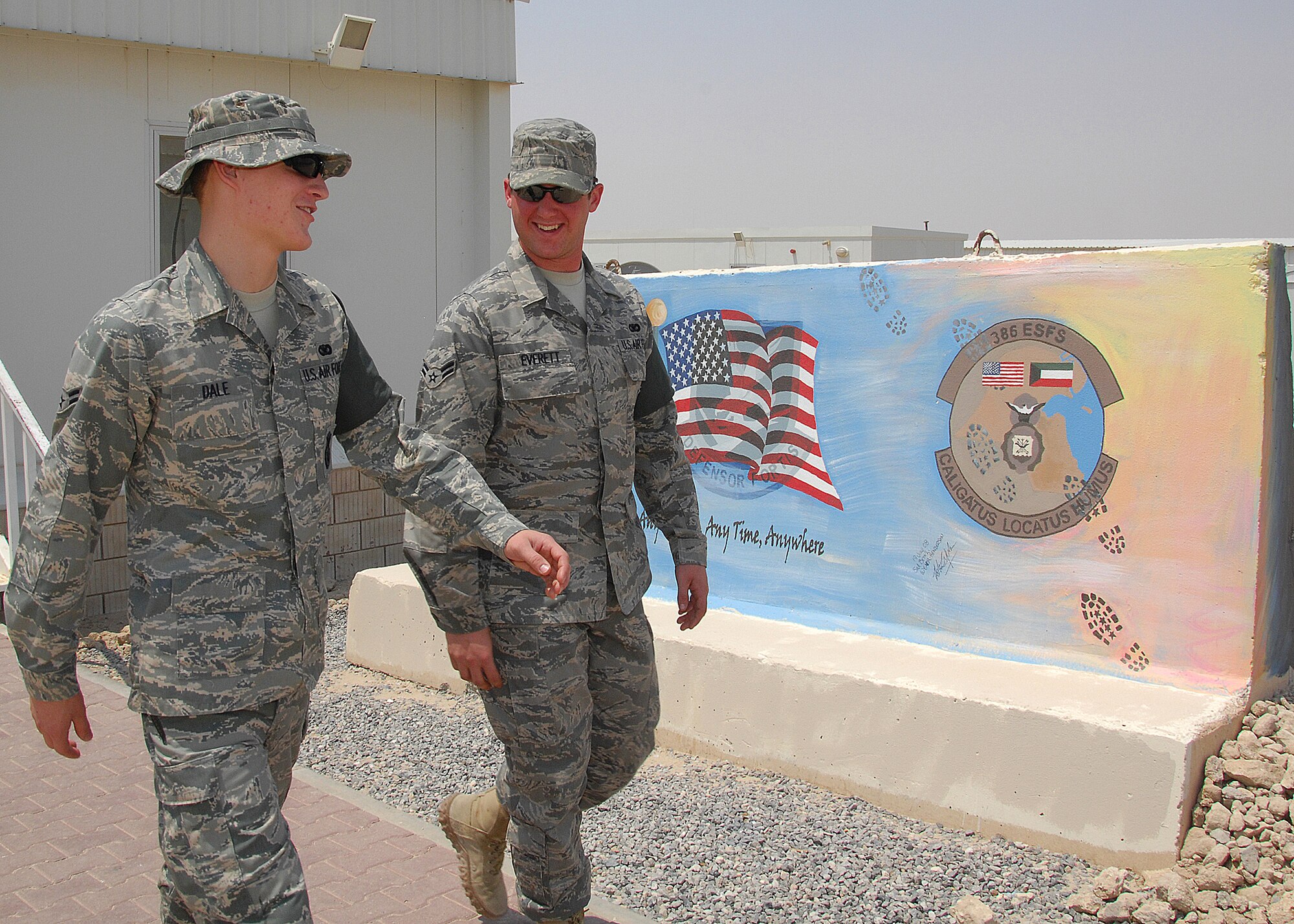 SOUTHWEST ASIA -- Airman 1st Class William Dale, left, and Airman 1st Class Thomas Everett, both assigned to the 386th Expeditionary Security Forces Squadron, talk on Aug. 26 about how quick thinking avoided a tragic incident at an air base in Southwest Asia. During a cargo mission in early August, Airman Everett saved Airman Dale from possible brain damage by oxygen deprivation. Airman Everett has been nominated for the Airman's Medal for his efforts. Both Airmen are deployed from Nellis Air Force Base, Nev. (U.S. Air Force photo/Tech. Sgt. Raheem Moore) 