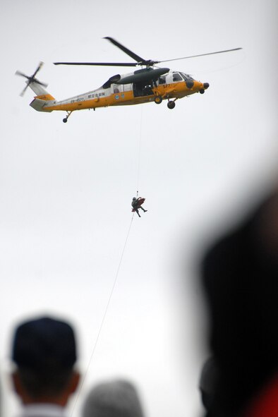 MISAWA AIR BASE, Japan -- An SH-60J, Japan Maritime Self-Defense Force helicopter, performs a simulated search and rescue for a crowd of Japanese locals and members of the base community during the 2008 Misawa Air Festival Sept. 7. The festival allowed the community a chance to come together, bond and witness a historic air show. (U.S. Air Force photo by Airman 1st Class Jamal D. Sutter) 