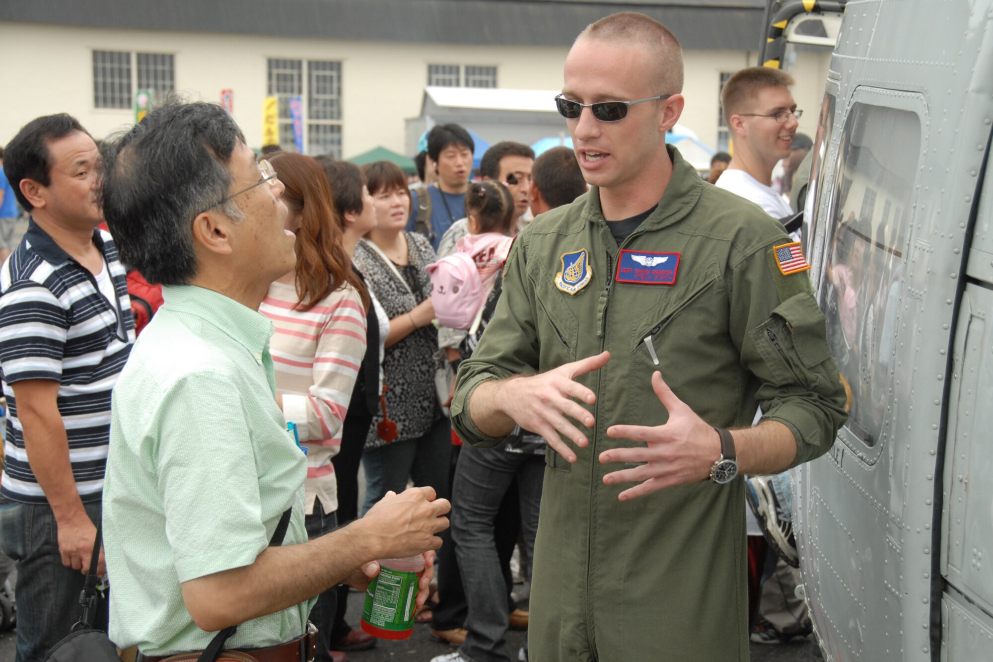 MISAWA AIR BASE, Japan -- Staff Sgt. David Grabher,  459th Airlift Squadron, Yokota Air Base, Japan, talks with an Aomori local during the 2008 Misawa Air Festival Sept. 7, 2008.   (U.S. Air Force photo by Airman 1st Class Jamal D. Sutter)