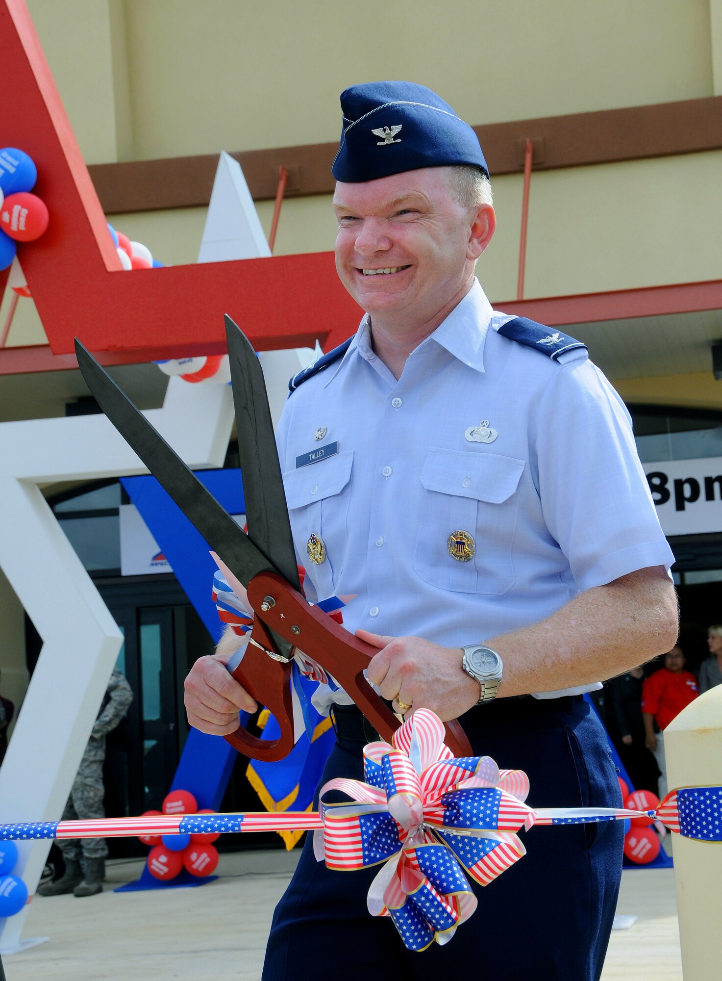 ANDERSEN AIR FORCE BASE, Guam -- Colonel Mark Talley, 36th Mission Support Group commander, waits with scissors in hand at the BX Grand Opening here Sept. 10. The new BX, located across the street from the Car Care Gas Station, provides a wide variety of services to meet Team Andersen Airmen's needs, including six restaurants, a computer repair shop, a hair salon and many more concession shops. The new BX hours of operation are 9 a.m. to 8 p.m., seven days a week, and from 10 a.m. to 6 p.m. on holidays. (U.S. Air Force photo by Airman 1st Class Courtney Witt)