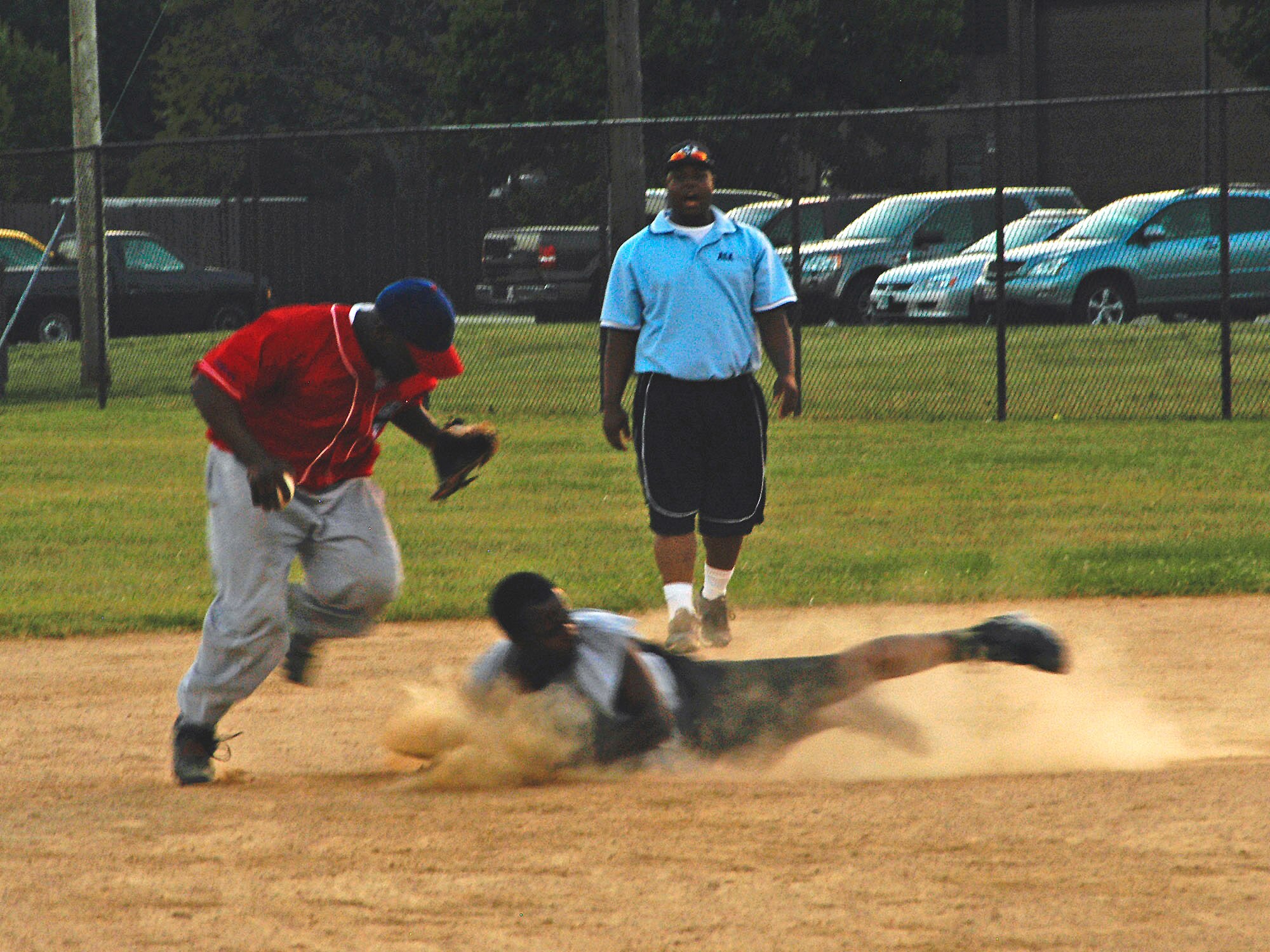 Adofo Willett, AFOSI Gators, moves out of the way of a sliding Corey English, 744th COMM, after a force out at second. The AFOSI Gators won the first game 16-2 and went on to claim the title in a close 4-2 win in the second game. (U.S. Air Force photo/Tech. Sgt John Jung)