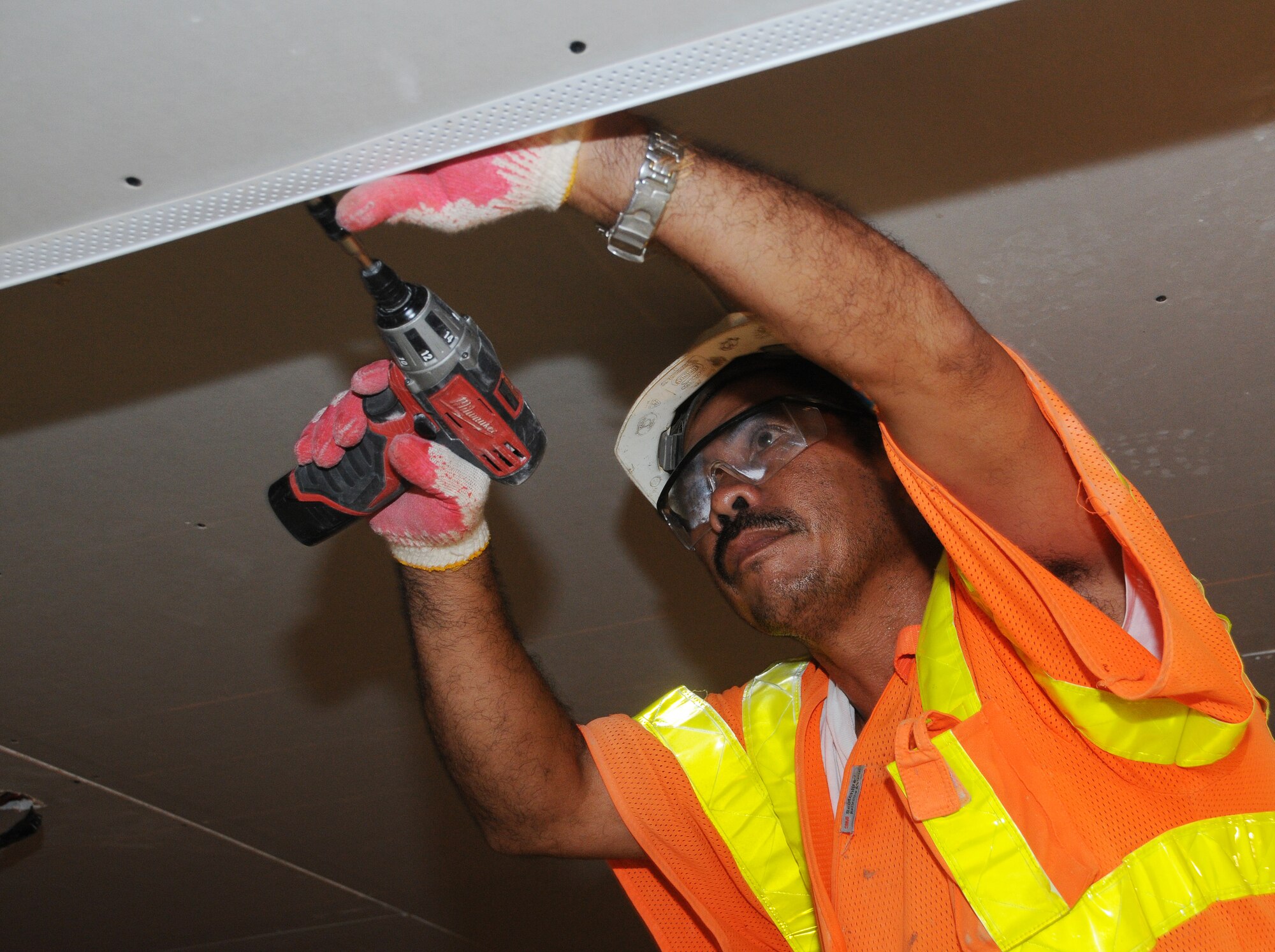 ANDERSEN AIR FORCE BASE, Guam - Meurcio Sapungan, a member of the Fargo Pacific, Inc., finishes a small section of the ceiling in the Magellan Inn dining facility here Sept. 9. The renovation project began June 1 and is expected to take three to four months to complete. (U.S. Air Force photo by Airman 1st Class Courtney Witt)