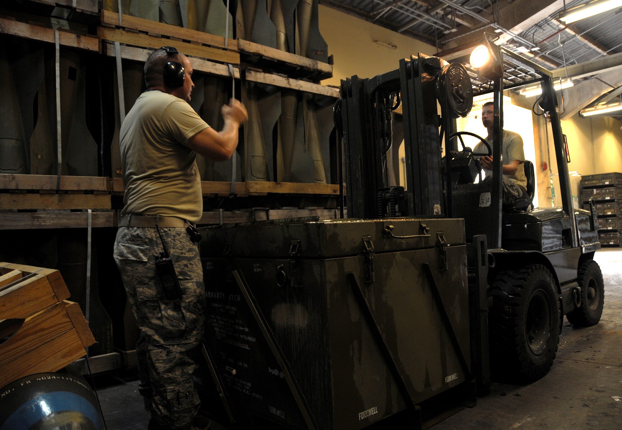 ANDERSEN AIR FORCE BASE, Guam - Staff Sgt. James Spillers directs a forklift into place here Sept. 8. The squadron is responsible for a huge storage area spanning over 5,500 acres and encompassing 143 storage facilities, seven operating locations, 23 sited storage revetments and 160 unsited revetments. (U.S. Air Force photo by Airman 1st Class Courtney Witt)