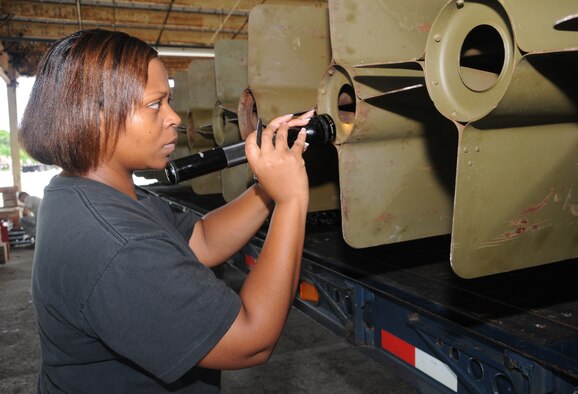 ANDERSEN AIR FORCE BASE, Guam - Staff Sgt. Jacqueline Franklin, 36th Munitions Squadron maintenance conventional crew chief, performs a seven-level check on a M117 bomb built here Sept. 8. The production flight provides assembly and delivery capability of all munitions types employed from Andersen. They maintain assembly proficiency for more than 30 types of bombs, missiles and countermeasures. They also maintain munitions handling trailers and associated handling equipment.  (U.S. Air Force photo by Airman 1st Class Courtney Witt)