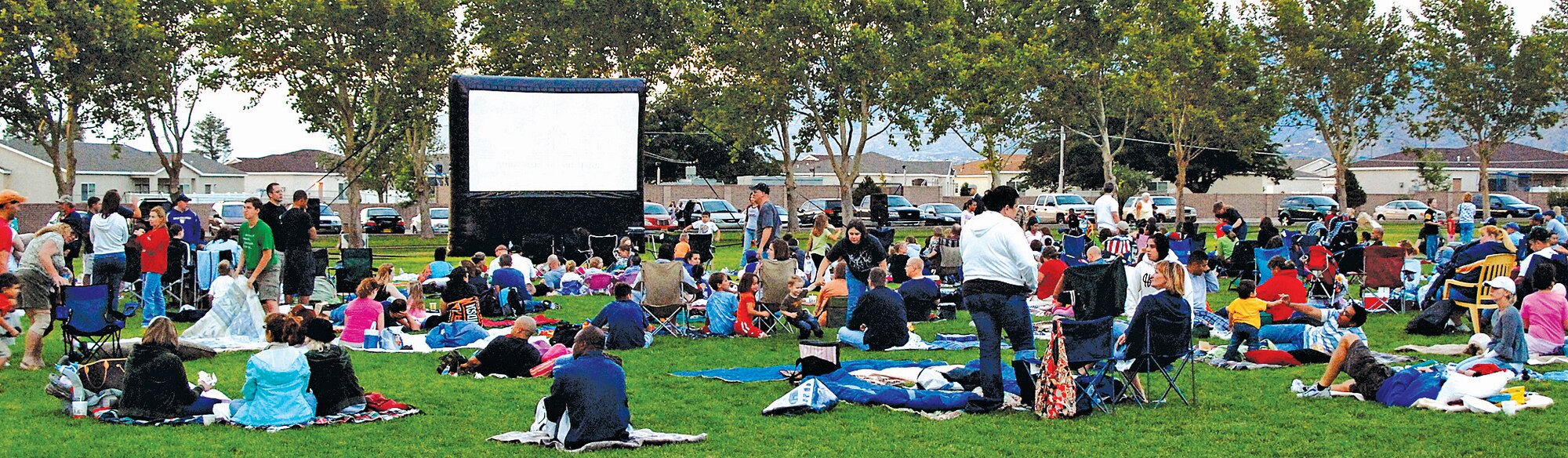 Team Kirtland members gather at Hardin Field Aug. 30, for the first Movie Under the Stars sponsored by Chief Master Sgt. Judith A. Ruiz, Air Force Nuclear Weapons Center command chief master sergeant. Watch the Nucleus for times and dates of future shows. U.S. Air Force photo by Damian Bohannon
