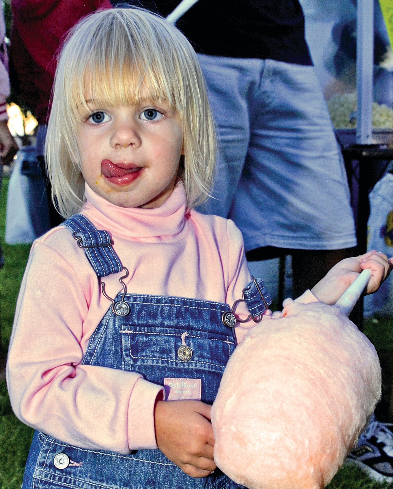 Lip licking good free cotton candy is thoroughly enjoyed by a youngster at the Movie Under the Stars, Aug. 28, at Hardin Field. U.S. Air Force photo by Damian Bohannon