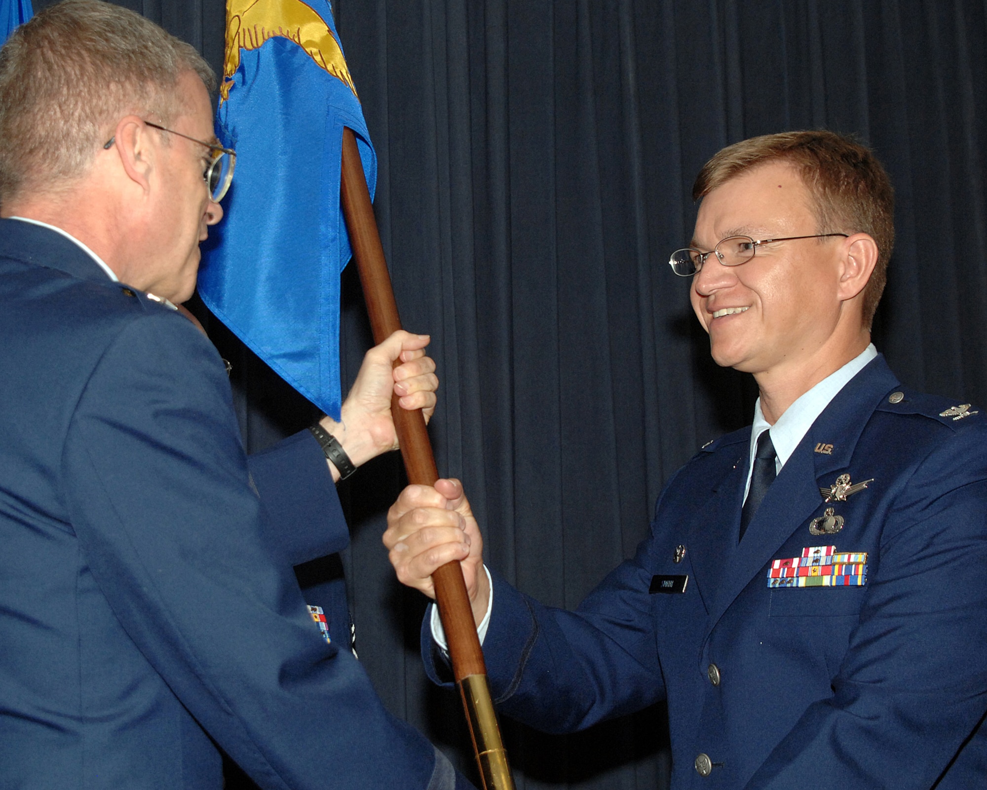 Col. Bradley J. Smith assumed command of the Phillips Research Site and Materiel Wing and Director, Space Vehicles Directorate here Aug. 18. Maj. Gen. Curtis M. Bedke, Air Force Research Laboratory commander, transferred the command. Colonel Smith?s previous assignment was as the commander, Defense Meteorological Satellite Program Systems Group, Los Angeles AFB, Calif. U.S. Air Force photo by Damian Bohannon
