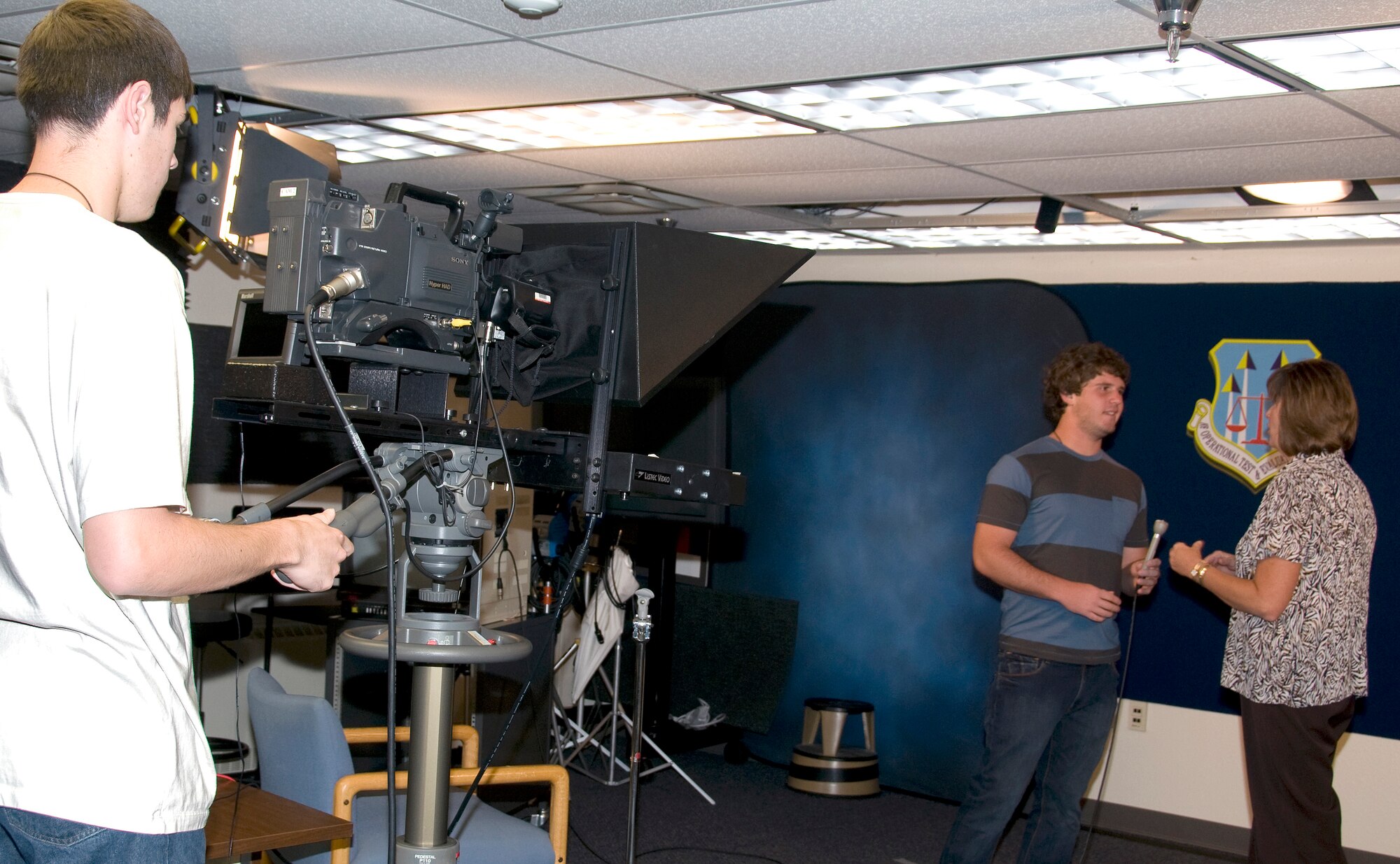 Ethan Halliday, left, a student intern with the Air Force Operational Test and Evaluation Center, operates the camera as Calum Murray, another AFOTEC student intern, practices his on-camera interviewing skills with Katherine Gandara, AFOTEC Chief of Public Affairs. Courtesy photo