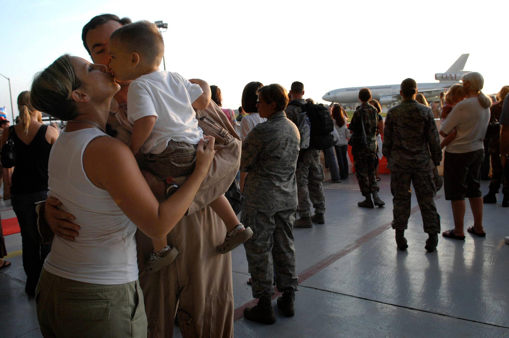 Tech. Sgt. Jasun Martinez, 4th Special Operations Squadron, kisses his wife and son as he arrives at Hurlburt Field, Fla.  Sept. 6. Operation Homecoming allows family, friends, and co-workers to reunite with their loved ones as soon as they land after a deployment. (U.S. Air Force photo/ Senior Airman Julianne Showalter)(RELEASED)