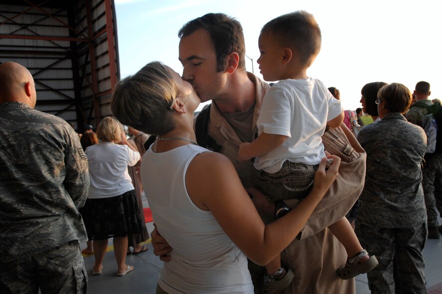 Tech. Sgt. Jasun Martinez, 4th Special Operations Squadron, kisses his wife and son after a deployment Sept. 6; Hurlburt Field, Fla. Operation Homecoming allows family, friends, and co-workers to reunite with their loved ones as soon as they land after a deployment. (U.S. Air Force photo/ Senior Airman Julianne Showalter)(RELEASED)